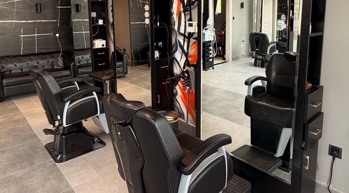 Modern salon interior at Hair Tag - Al Jaddaf, Dubai, AE with stylish black chairs and decor.