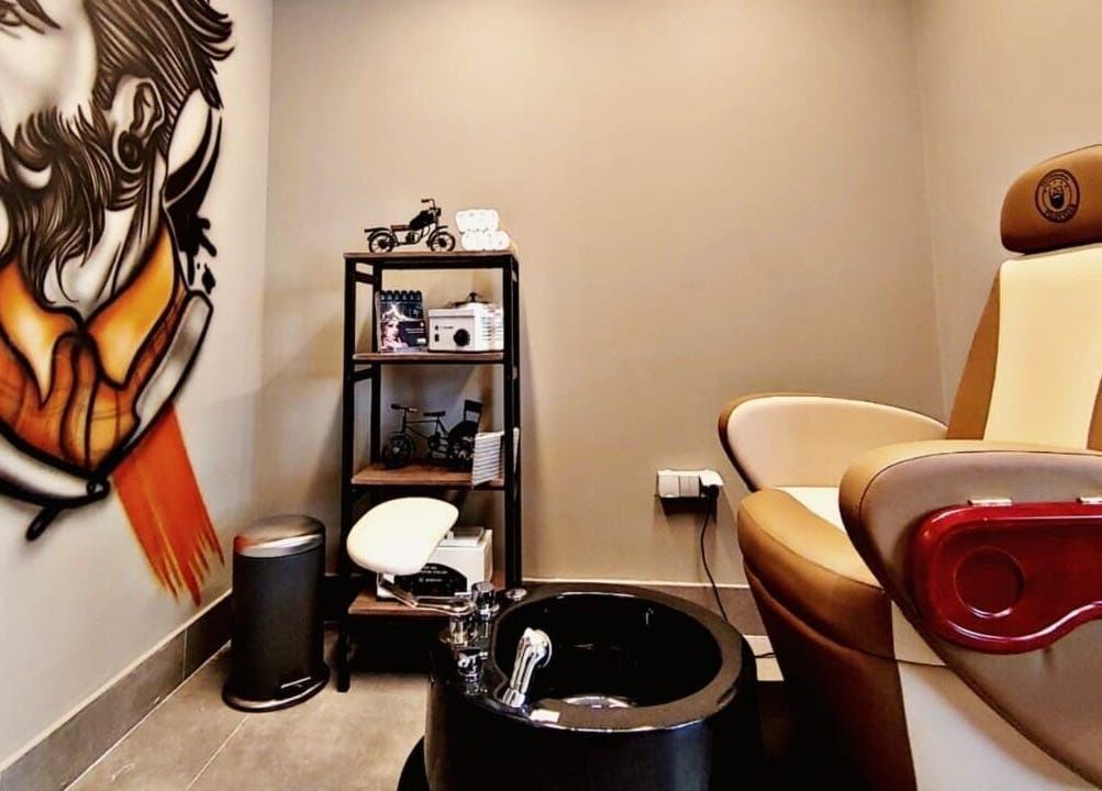 Hair Tag - Al Jaddaf's elegant grooming corner with mural and plush seating in Dubai, AE.