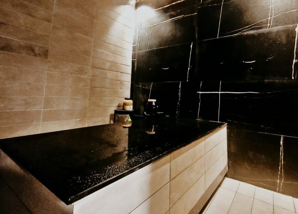 Luxurious spa room at Hair Tag - Al Jaddaf, Dubai, AE with a comfortable massage table and elegant decor.