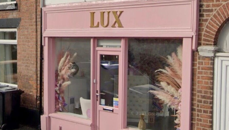 Front view of LUX beauty venue showcasing pink exterior in Congleton, England, GB.