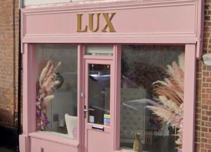 Front view of LUX beauty venue showcasing pink exterior in Congleton, England, GB.