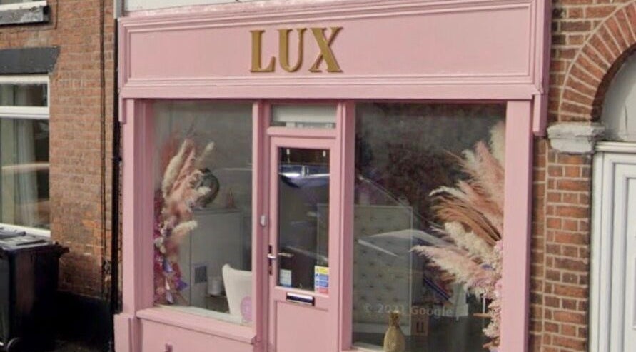 Front view of LUX beauty venue showcasing pink exterior in Congleton, England, GB.