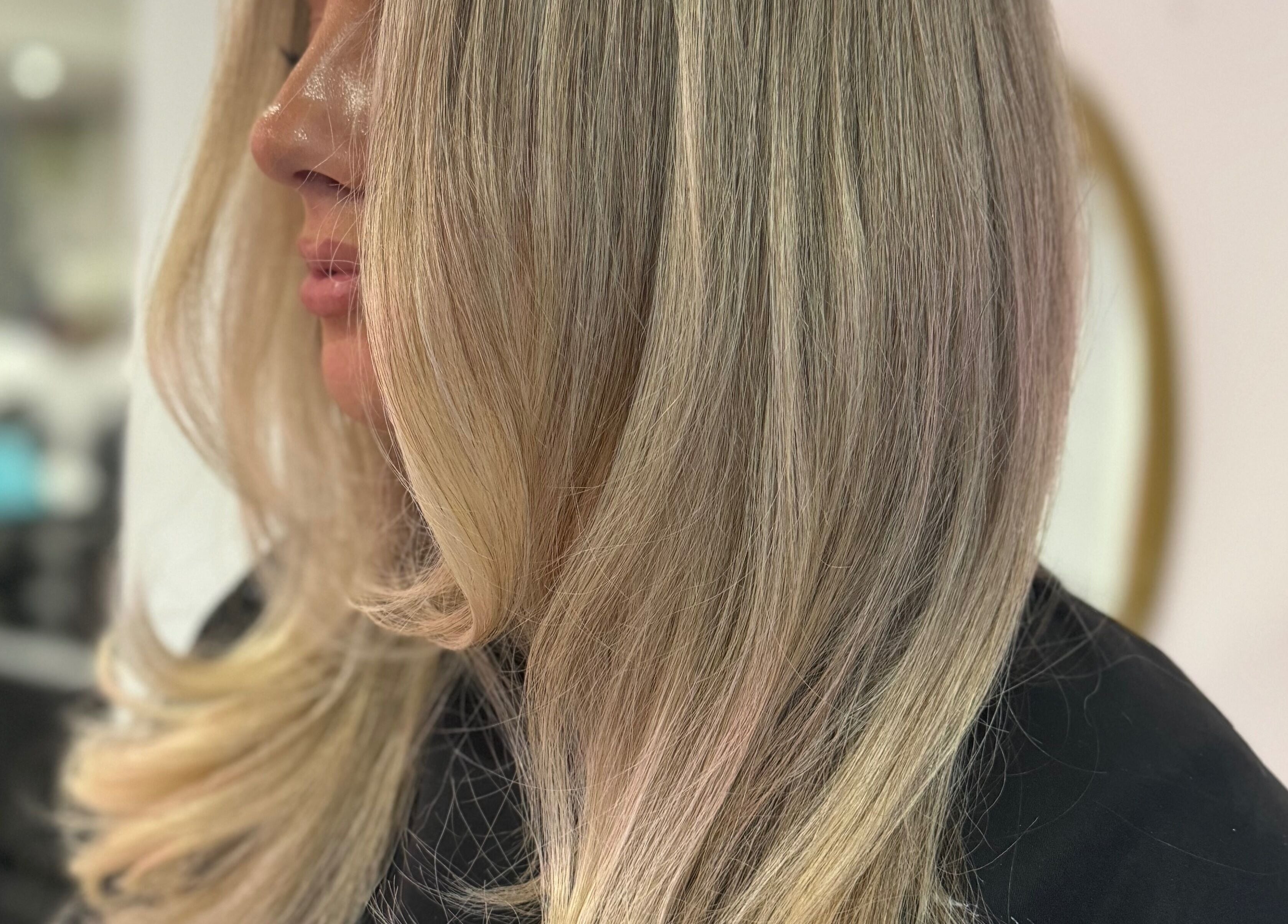 Blonde hair styling at LUX salon, Congleton, England, GB for a sleek look.