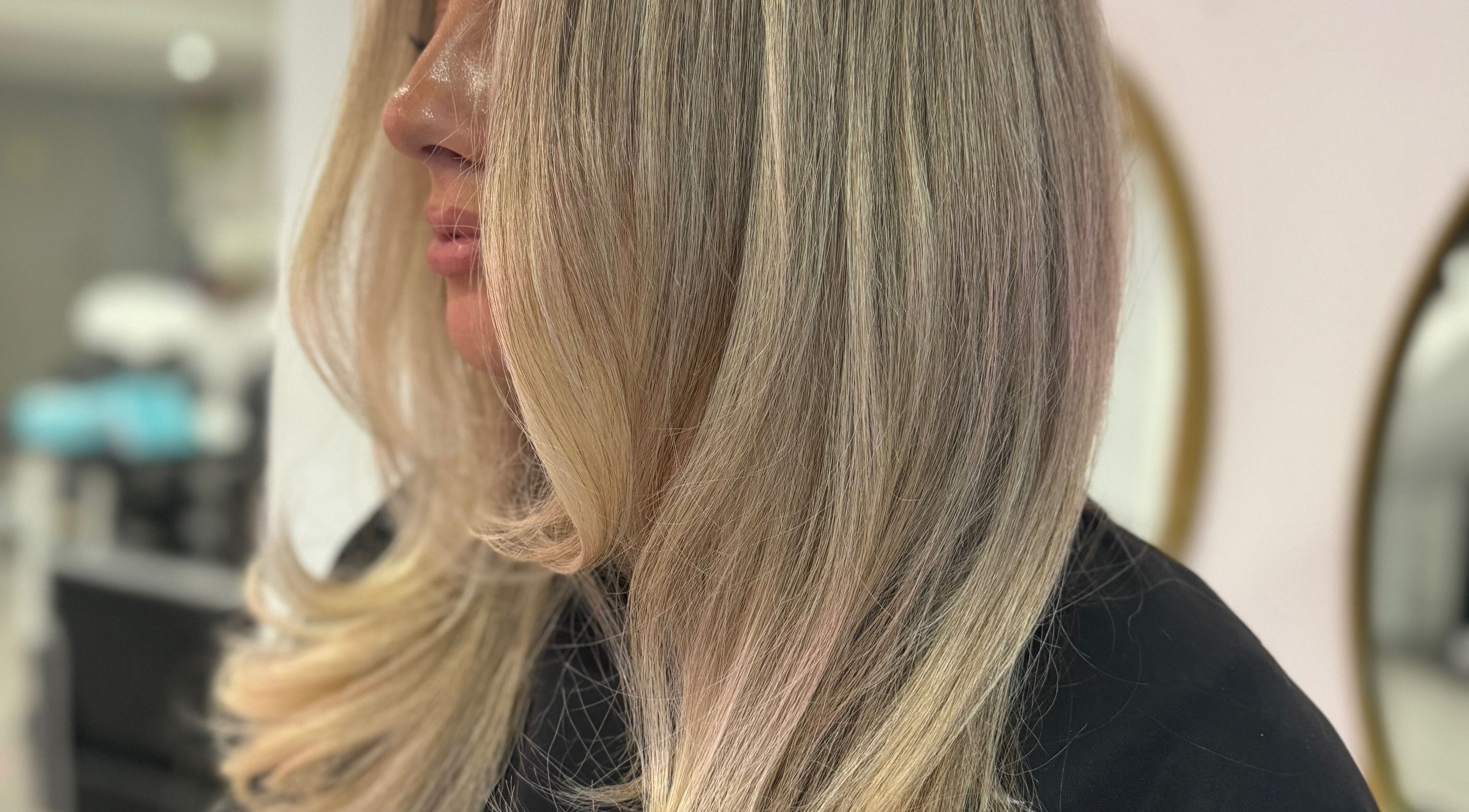 Blonde hair styling at LUX salon, Congleton, England, GB for a sleek look.