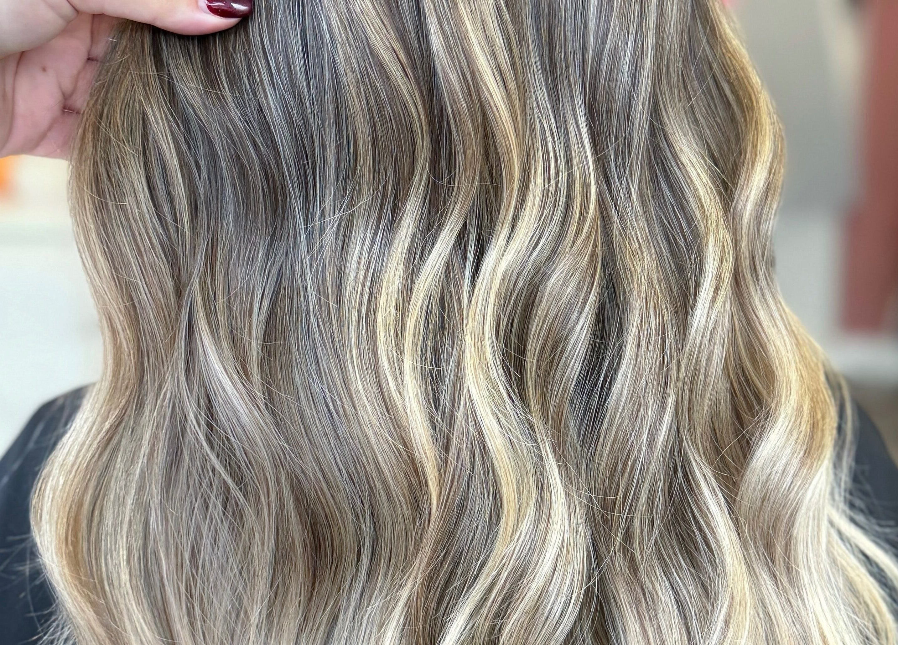 Luxurious wavy hairstyle at LUX, Congleton, England, GB. Perfect blend of blonde highlights for a radiant look.