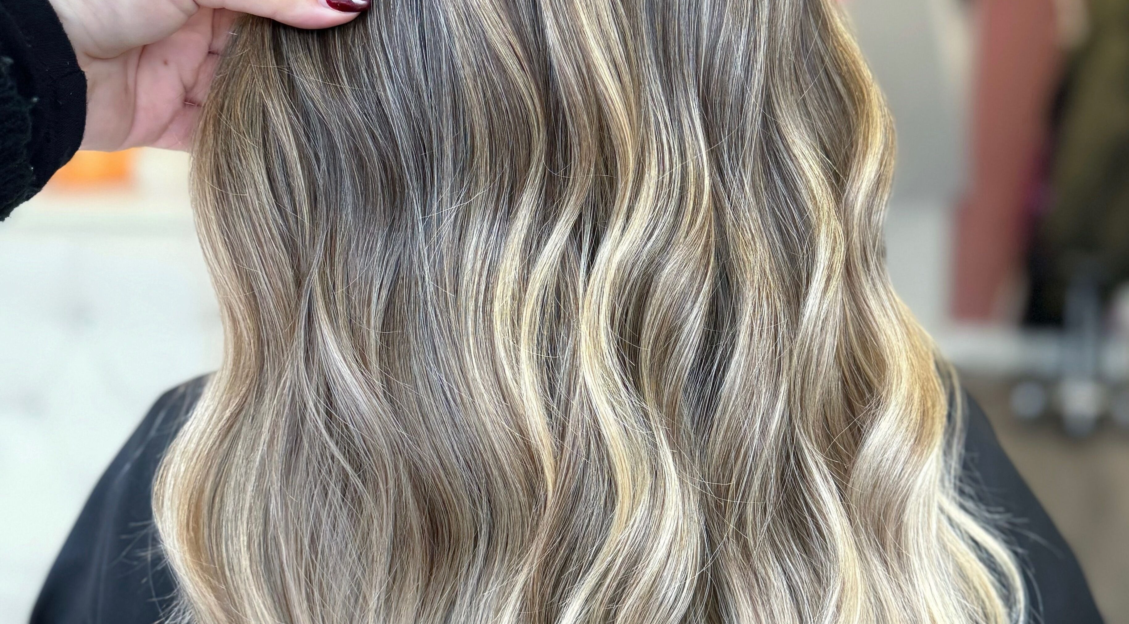 Luxurious wavy hairstyle at LUX, Congleton, England, GB. Perfect blend of blonde highlights for a radiant look.