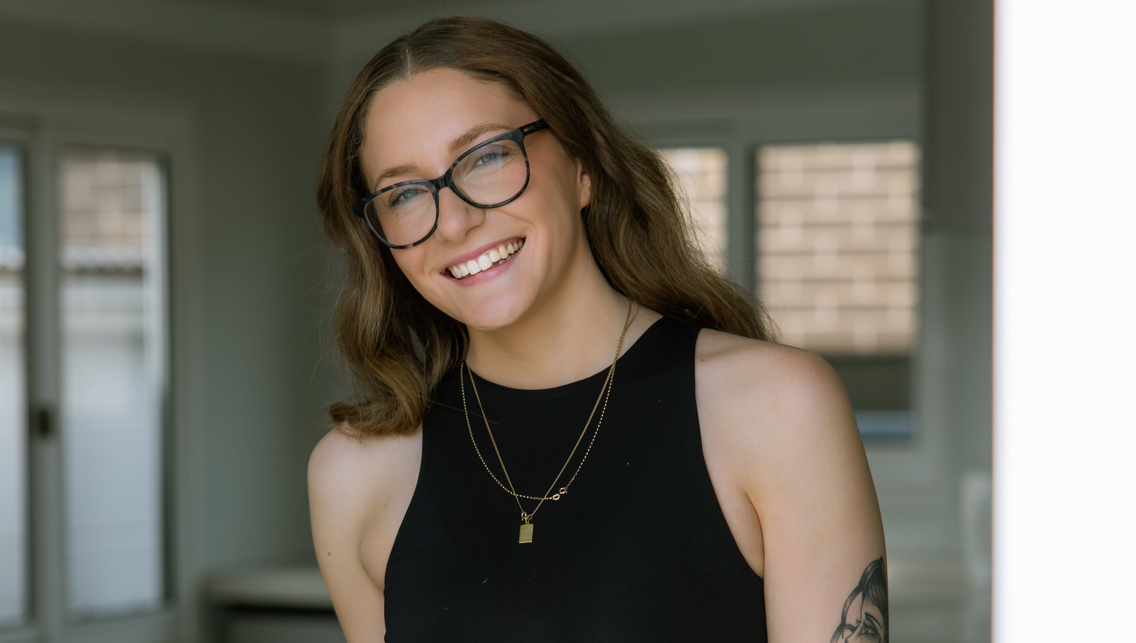 Smiling individual at Loved By Laird, Gorokan, New South Wales, AU, embodying wellness and style.