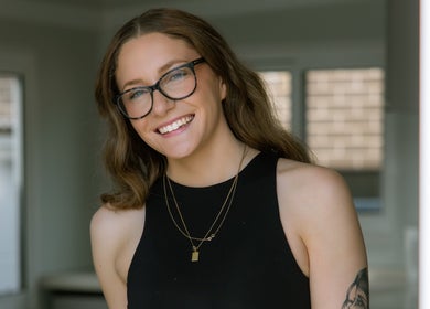 Smiling individual at Loved By Laird, Gorokan, New South Wales, AU, embodying wellness and style.