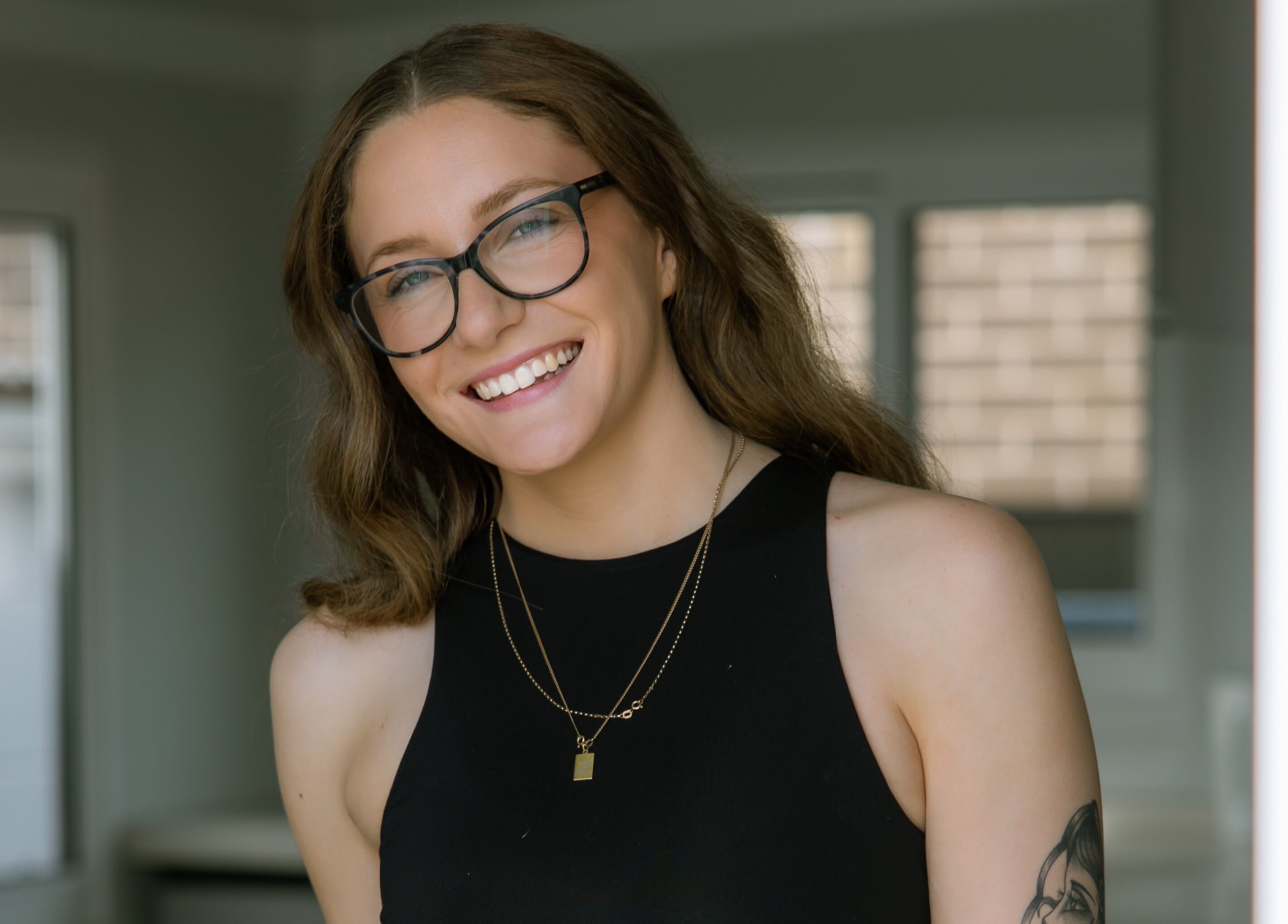 Smiling individual at Loved By Laird, Gorokan, New South Wales, AU, embodying wellness and style.