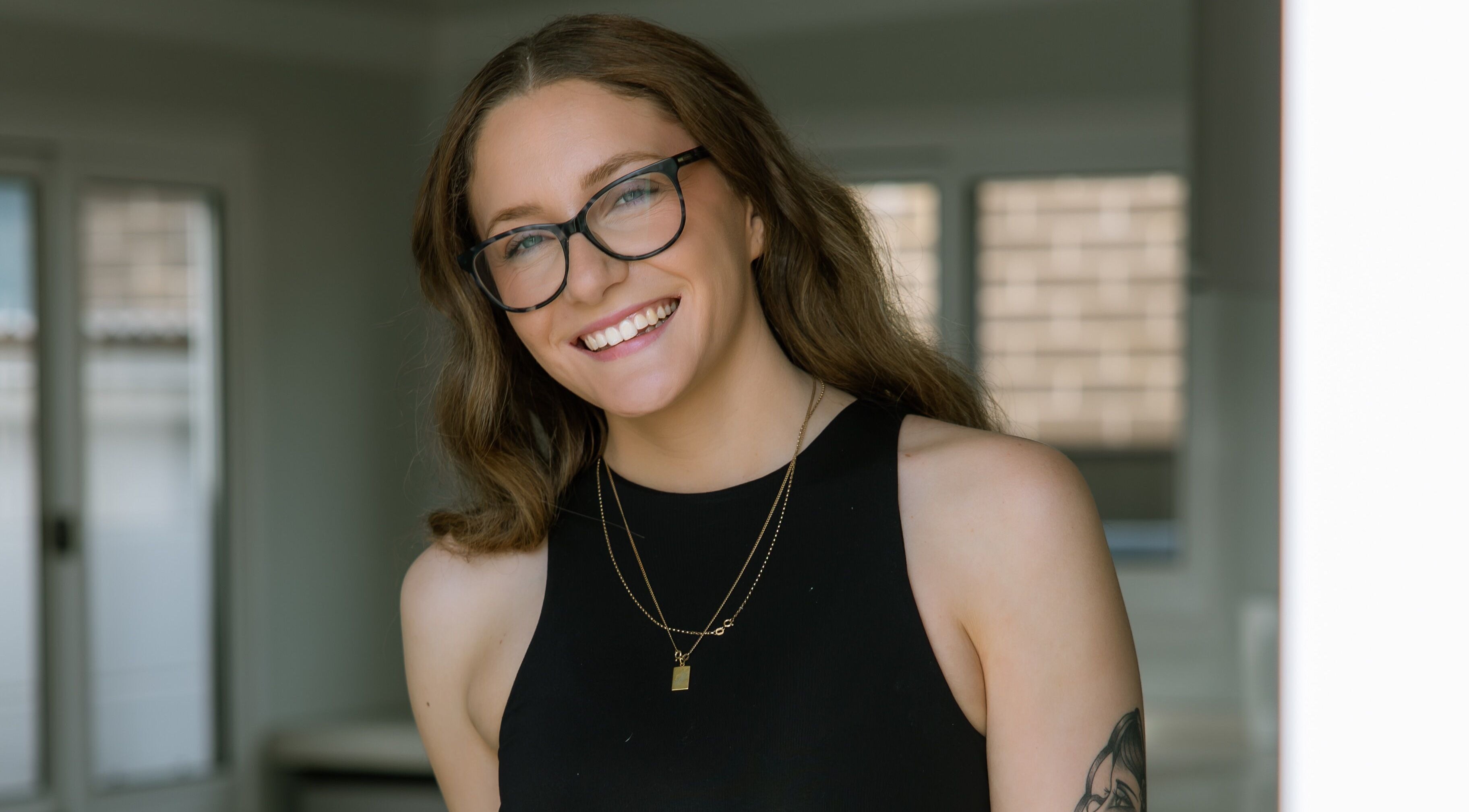 Smiling individual at Loved By Laird, Gorokan, New South Wales, AU, embodying wellness and style.