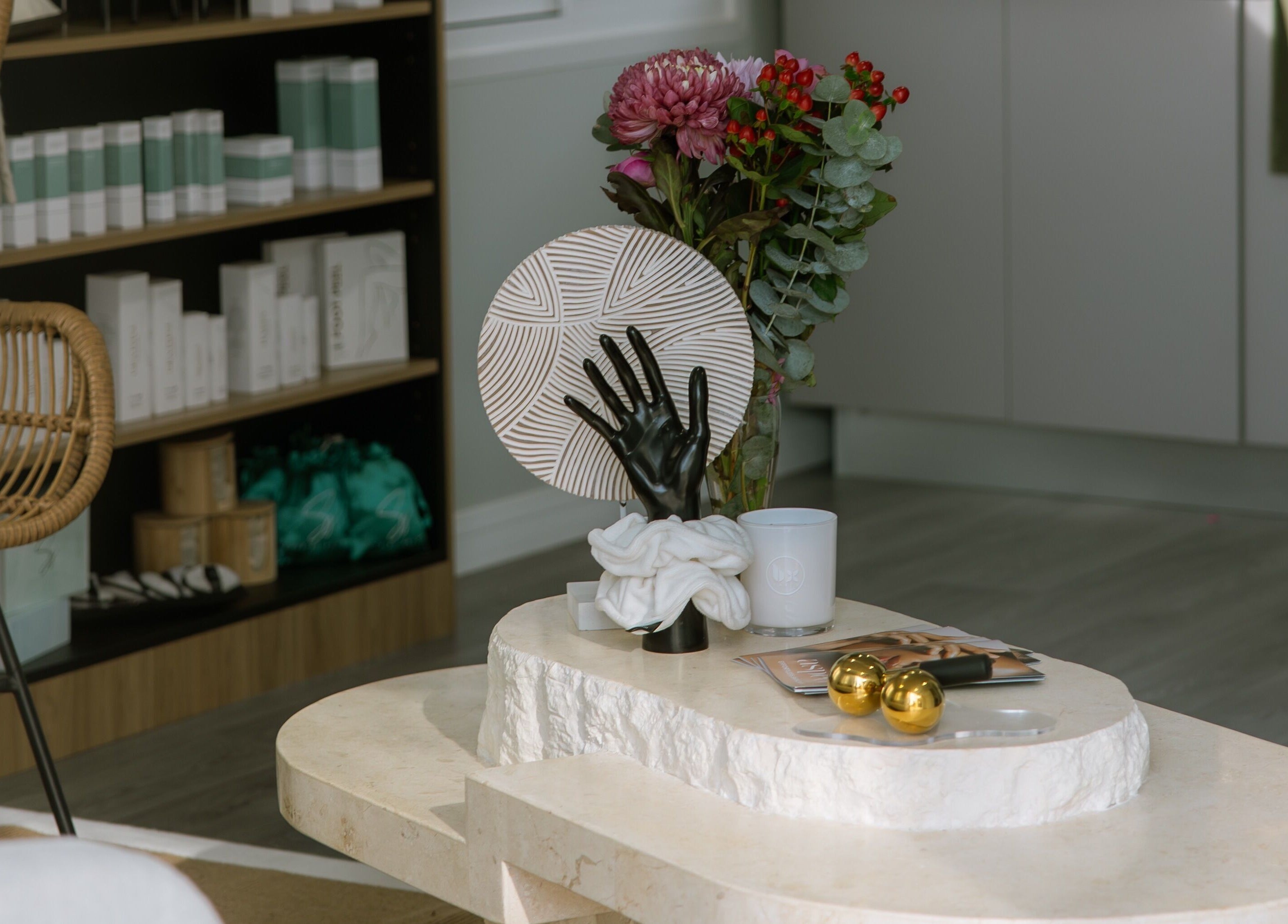 Stylish decor at Loved By Laird, Gorokan, New South Wales, AU, featuring modern table and elegant floral arrangement.