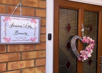 Entrance sign and floral wreath at Jessica Lily Beauty in Long Buckby, England, GB.