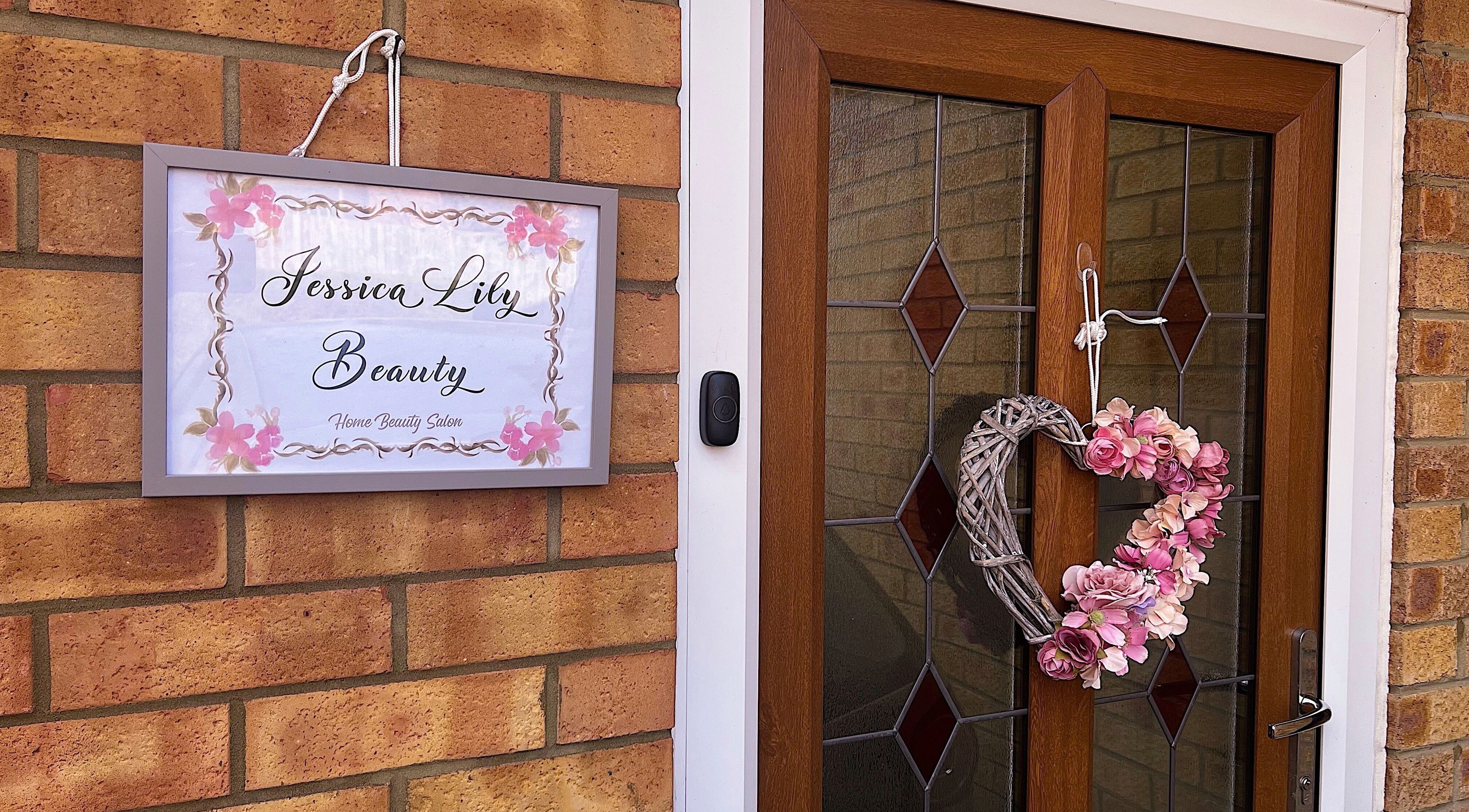 Entrance sign and floral wreath at Jessica Lily Beauty in Long Buckby, England, GB.
