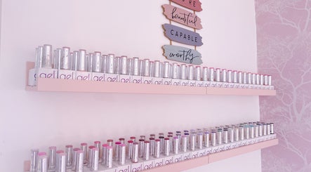 Shelf of vibrant nail polishes at Jessica Lily Beauty, Long Buckby, England, GB, under motivational signs.