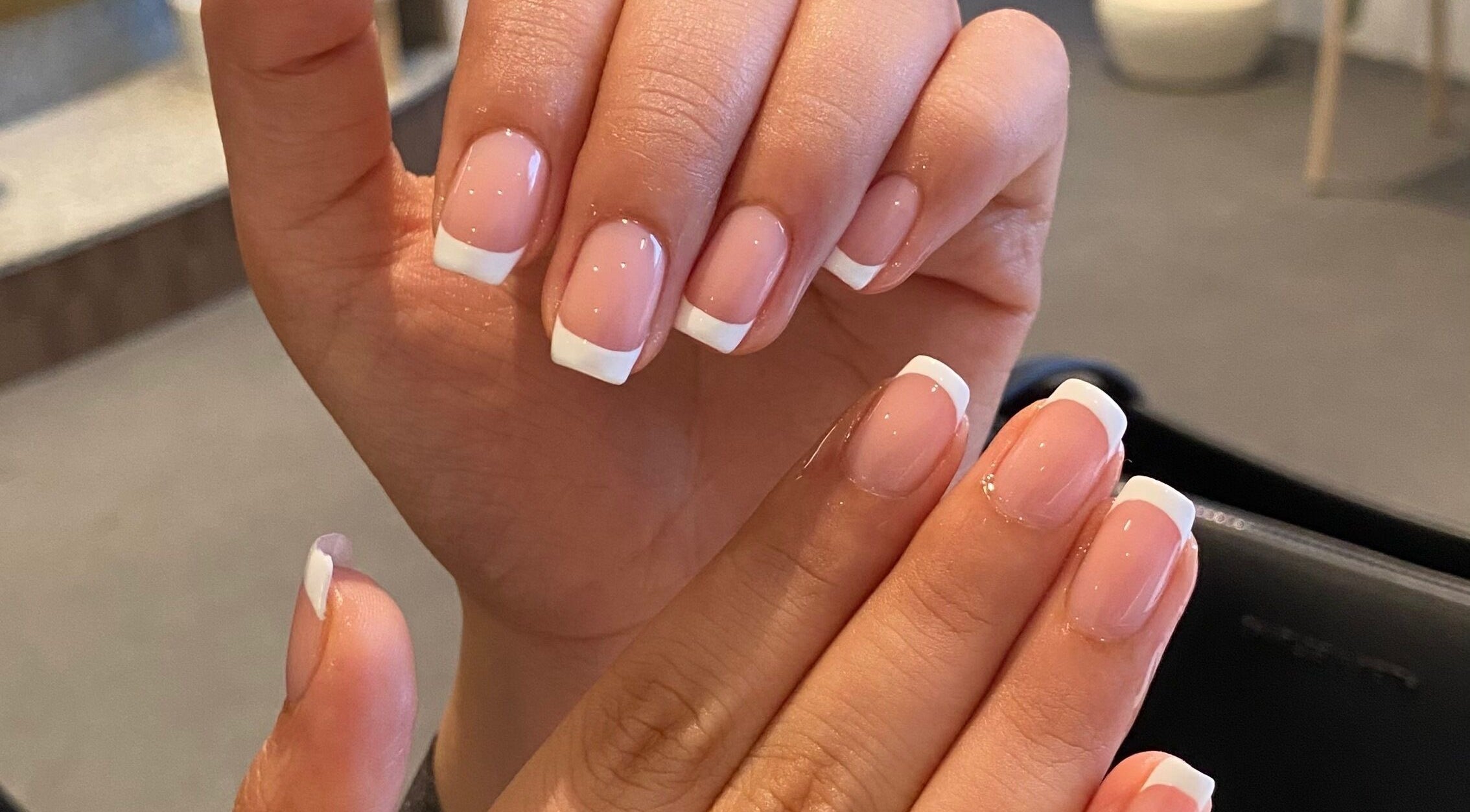 Elegant French manicure at Udaa Beauty, showcasing refined nail art in Muizenburg, Western Cape, ZA.
