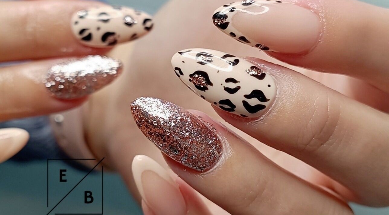 Stylish leopard print and glitter nails at Enchanted Belle, Boksburg, Gauteng, ZA.
