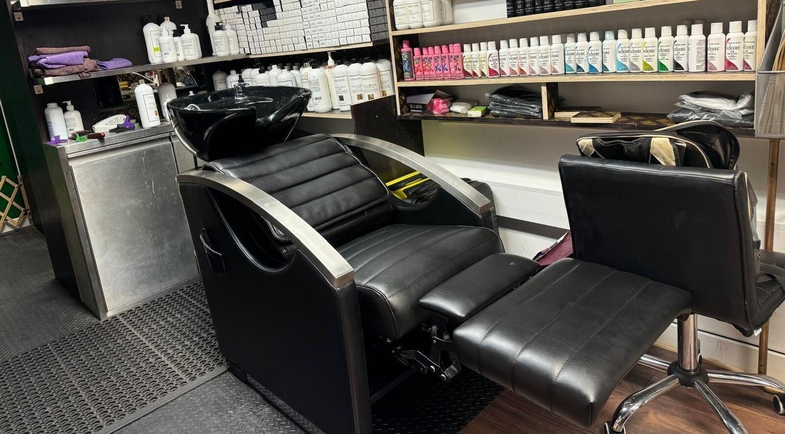 Modern salon chair at Scissorhands/OP Cosmetics London Ltd, London, England, GB, surrounded by hair care products.