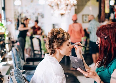 Makeup artist applies cosmetics in Esstudio Galleria, Chippendale, New South Wales, AU vibrant salon setting.