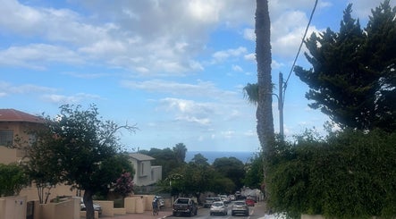Scenic street view near Forever Fit ZY in Zihron Ya'akov, Haifa District, IL, overlooking the ocean.