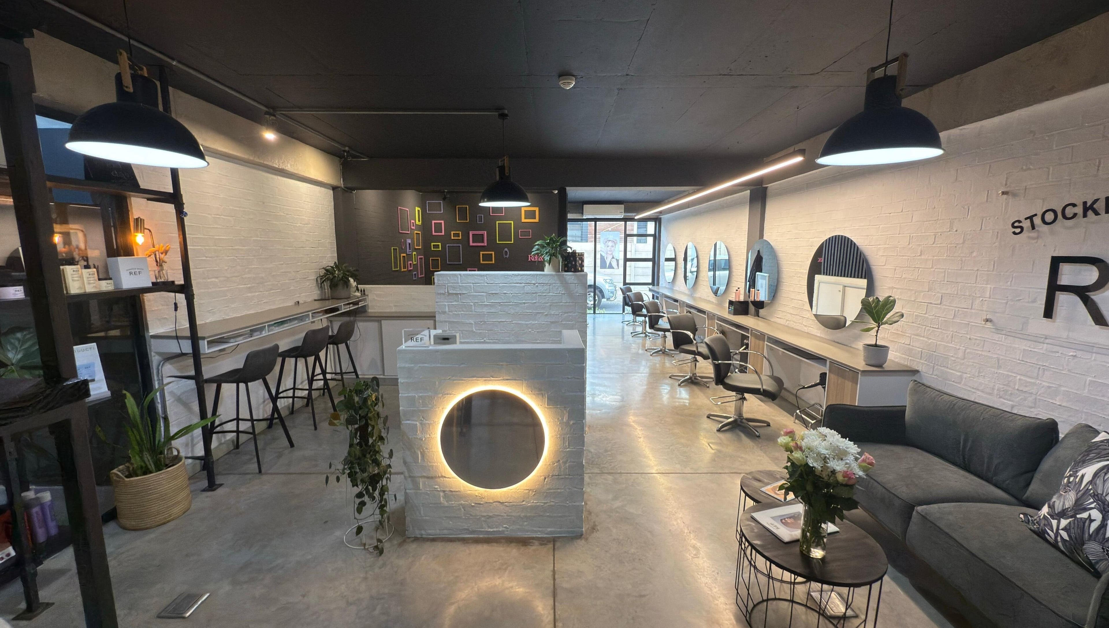 Modern salon interior of The Dome Hair Design in Gqeberha, Eastern Cape, ZA with stylish decor and seating.