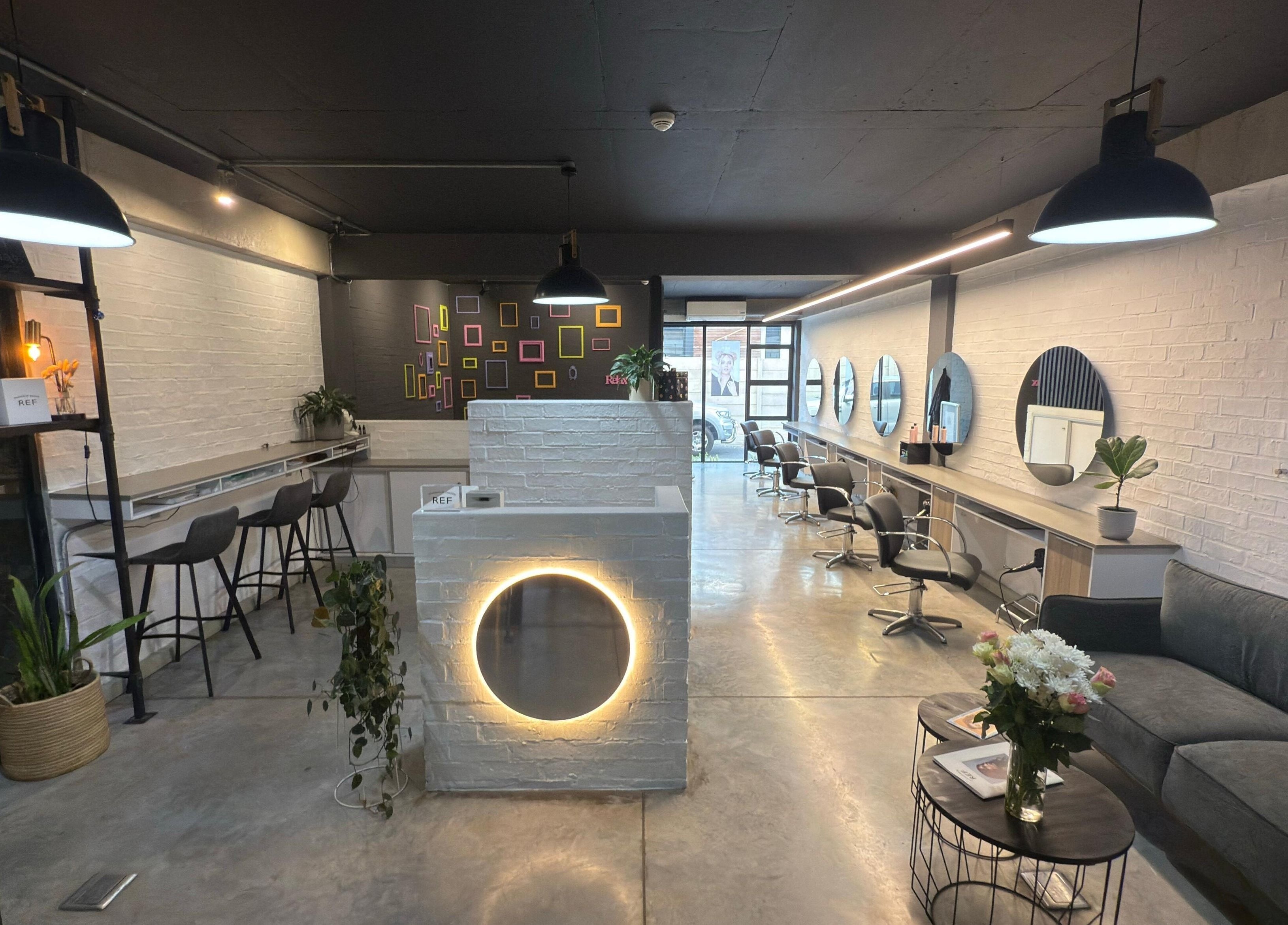 Modern salon interior of The Dome Hair Design in Gqeberha, Eastern Cape, ZA with stylish decor and seating.