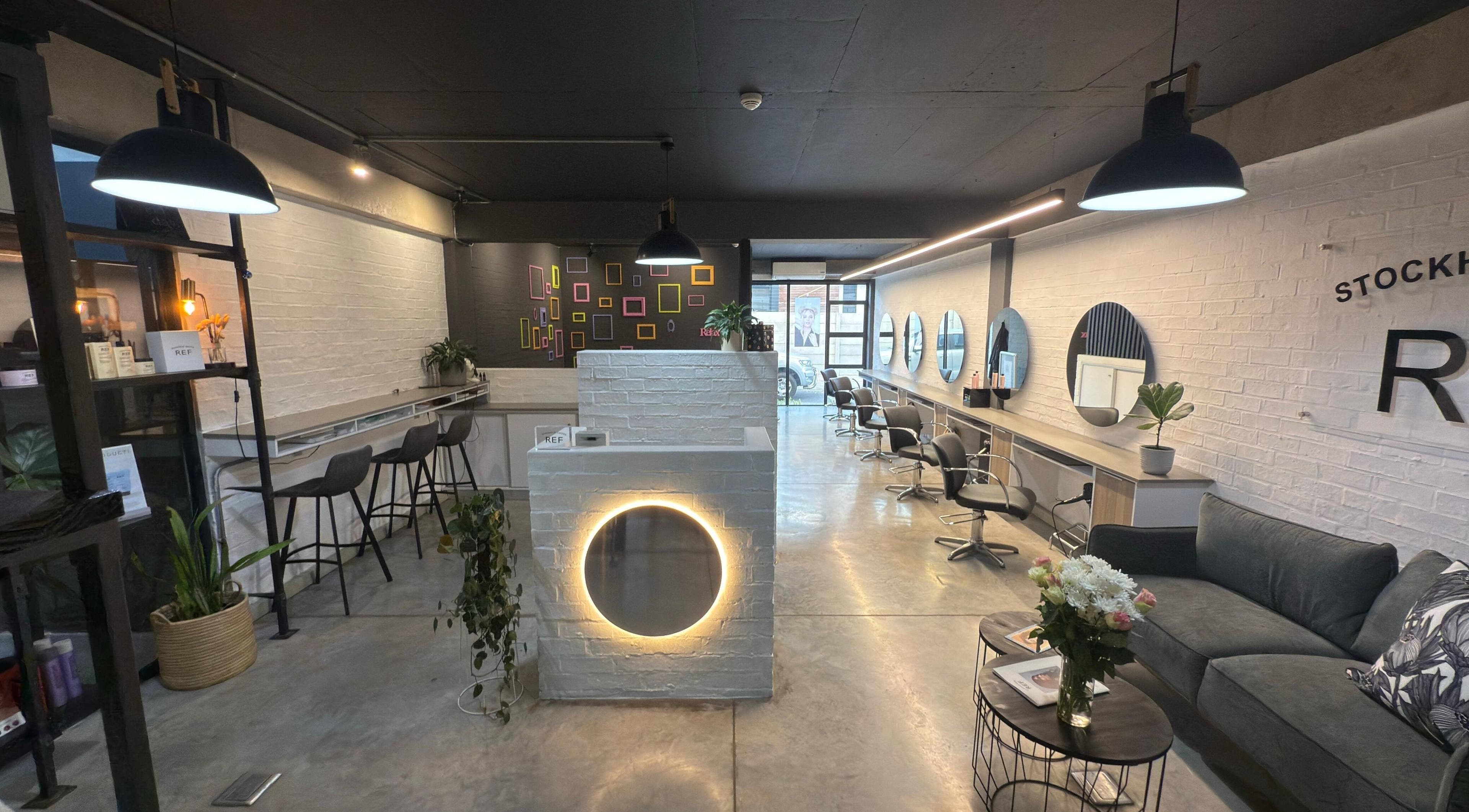 Modern salon interior of The Dome Hair Design in Gqeberha, Eastern Cape, ZA with stylish decor and seating.