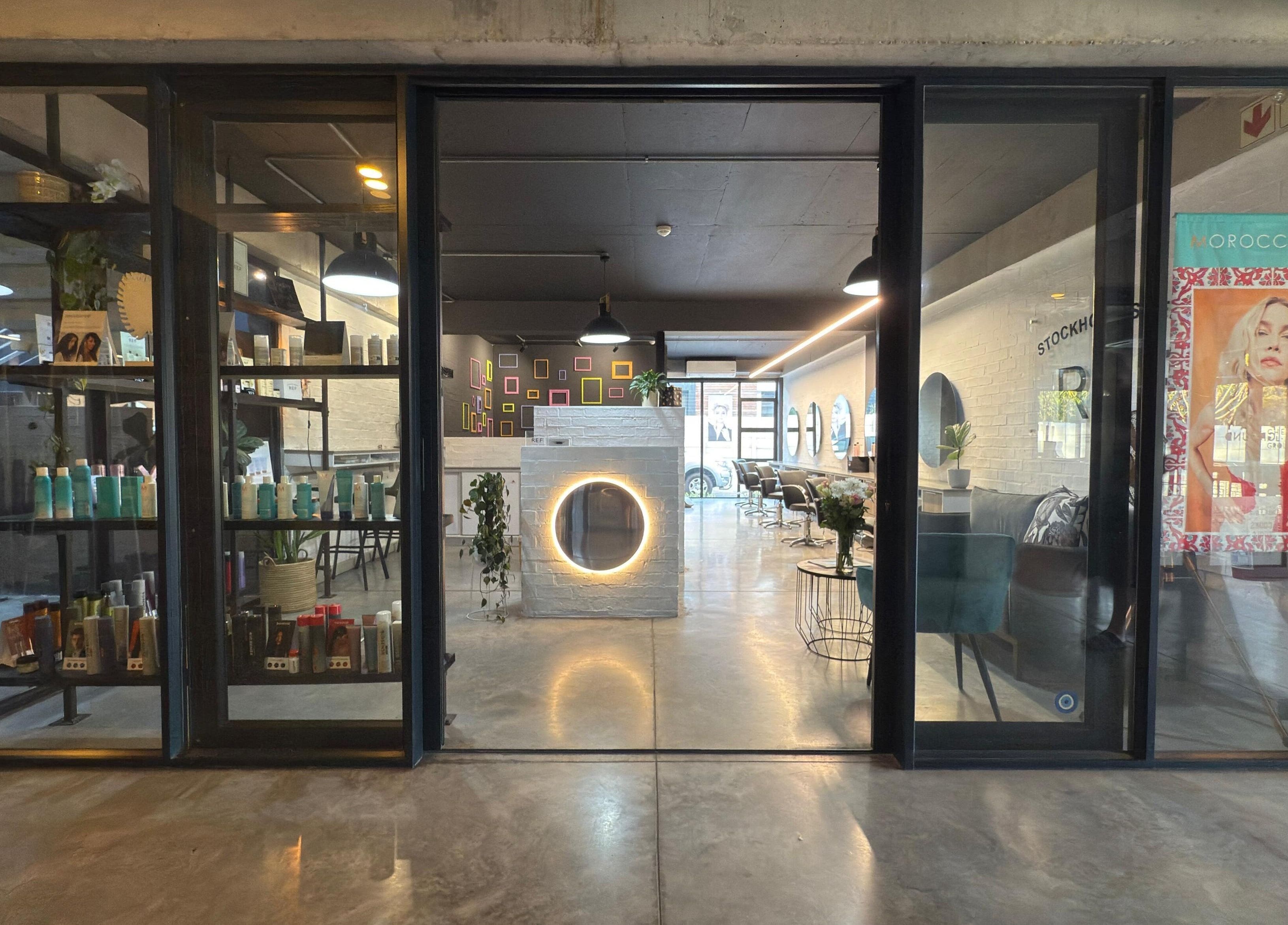 Entrance of The Dome Hair Design in Gqeberha, Eastern Cape, ZA showcasing a chic interior salon setting.