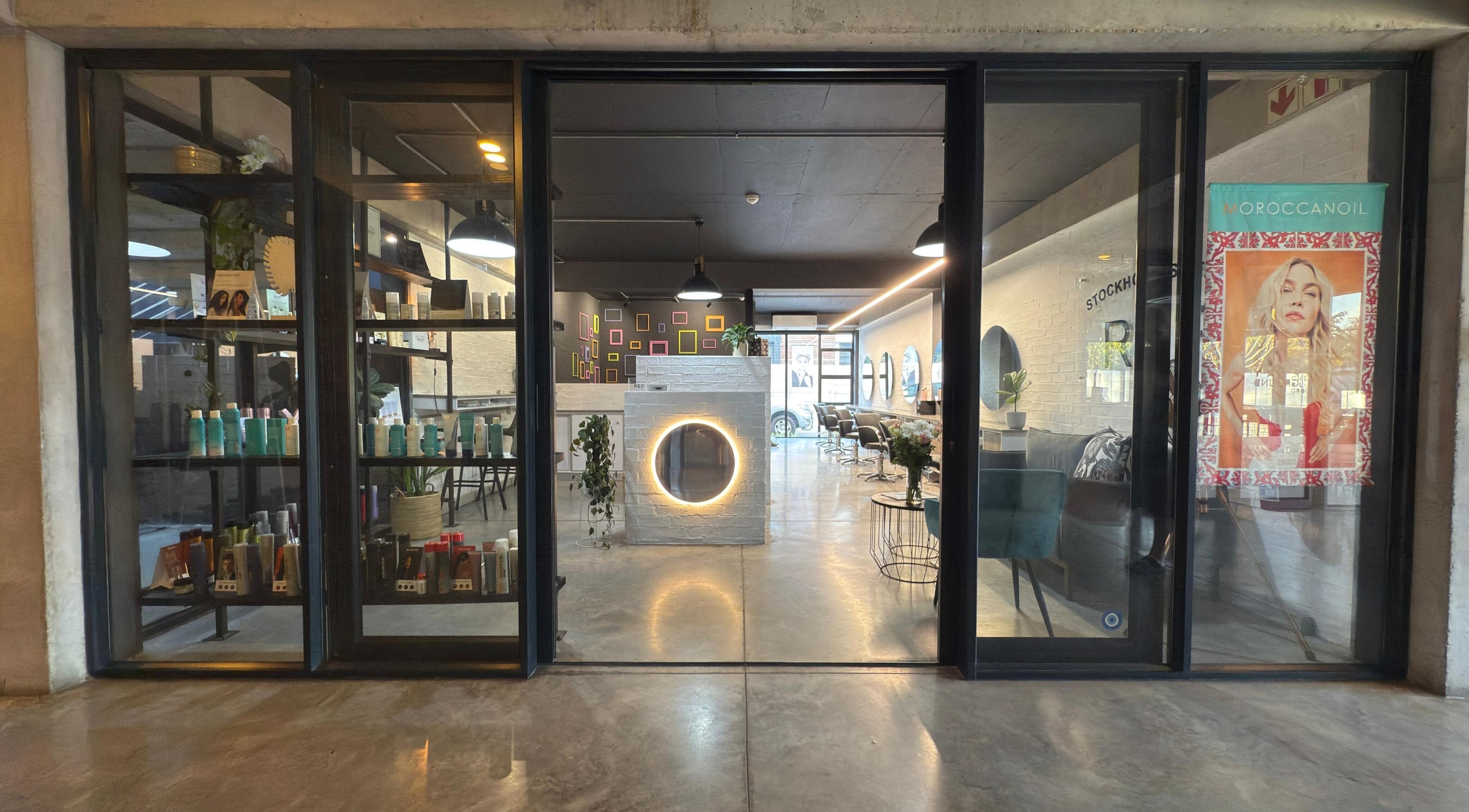 Entrance of The Dome Hair Design in Gqeberha, Eastern Cape, ZA showcasing a chic interior salon setting.