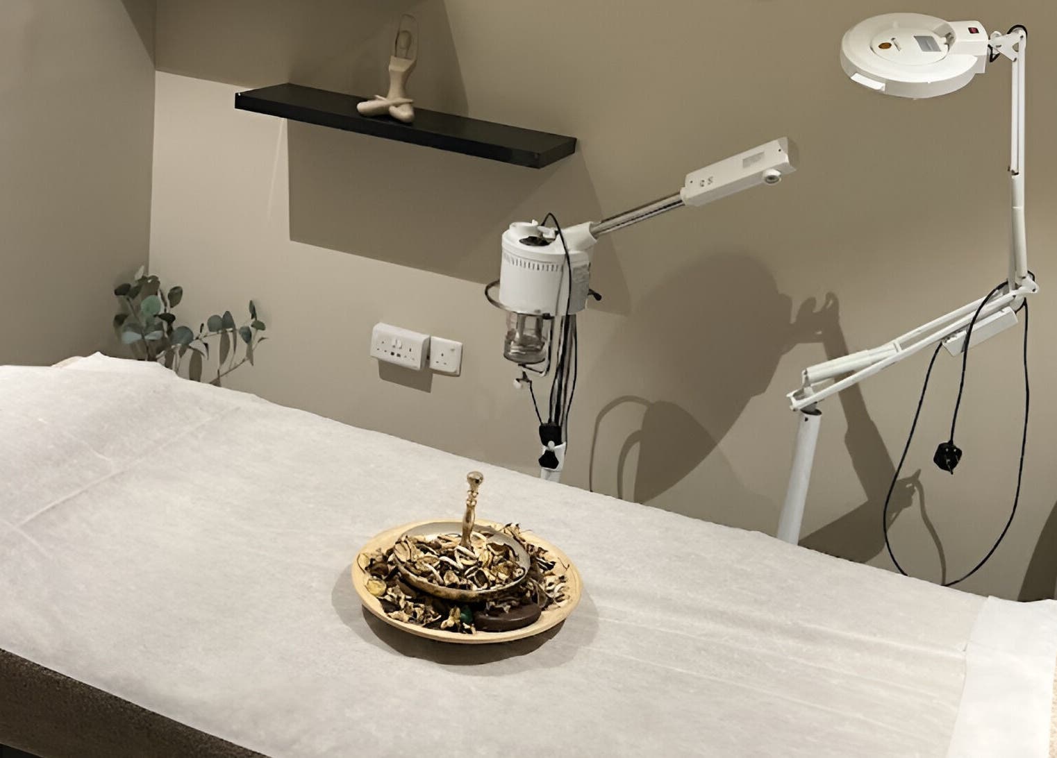 ZK Beauty & Spa treatment room in Muscat, Muscat Governorate, OM with a cream treatment bed and décor.