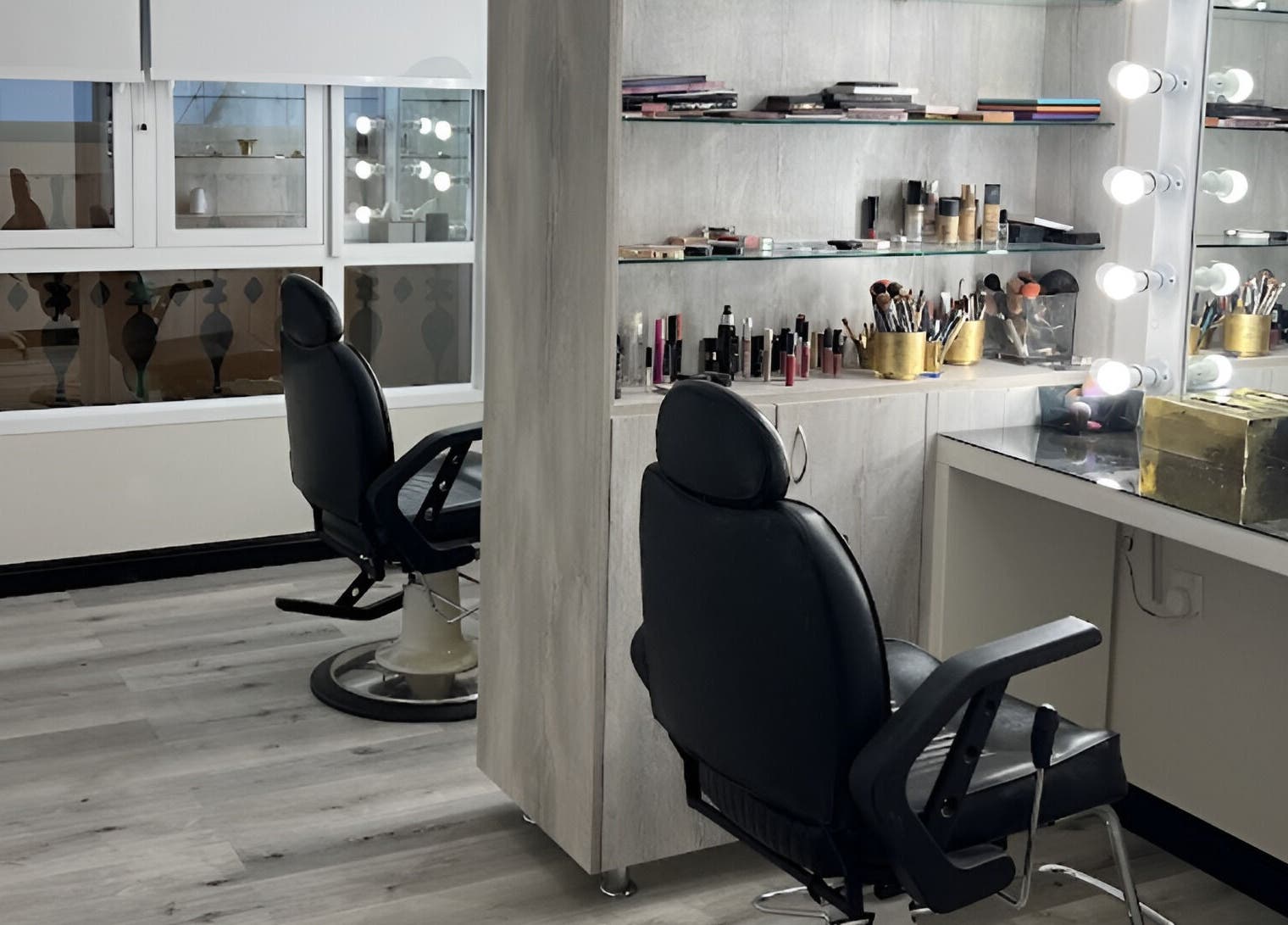 Elegant makeup vanity at ZK Beauty & Spa, Muscat, Muscat Governorate, OM, featuring modern chairs and illuminated mirrors.