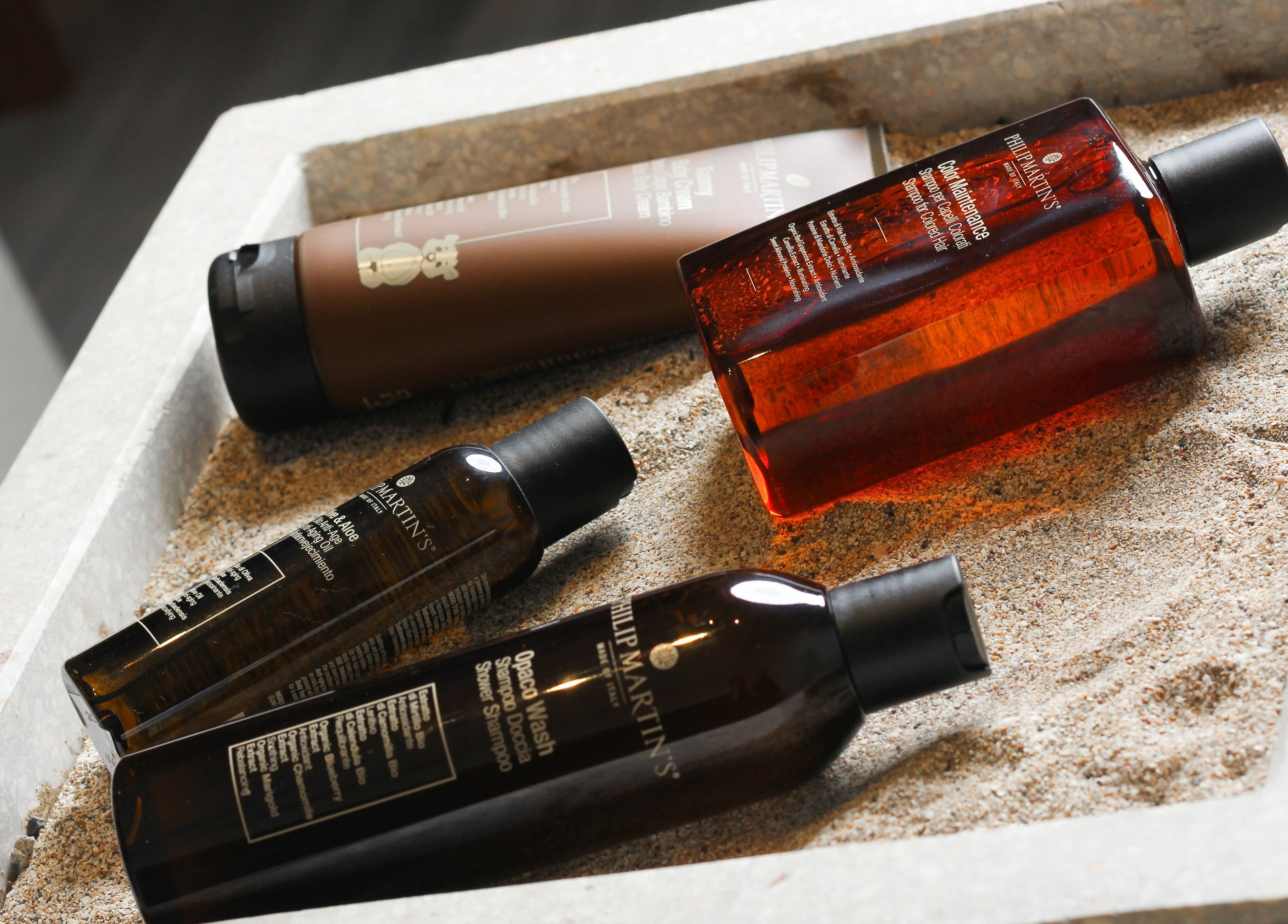 Luxury spa products displayed in sand at ZK Beauty & Spa, Muscat, Muscat Governorate, OM.