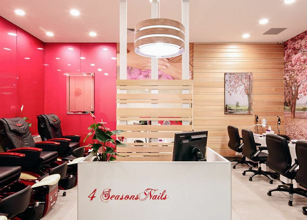 Modern interior of 4 Seasons Nails Queensgate in Lower Hutt, Wellington, NZ featuring plush seating and vibrant decor.