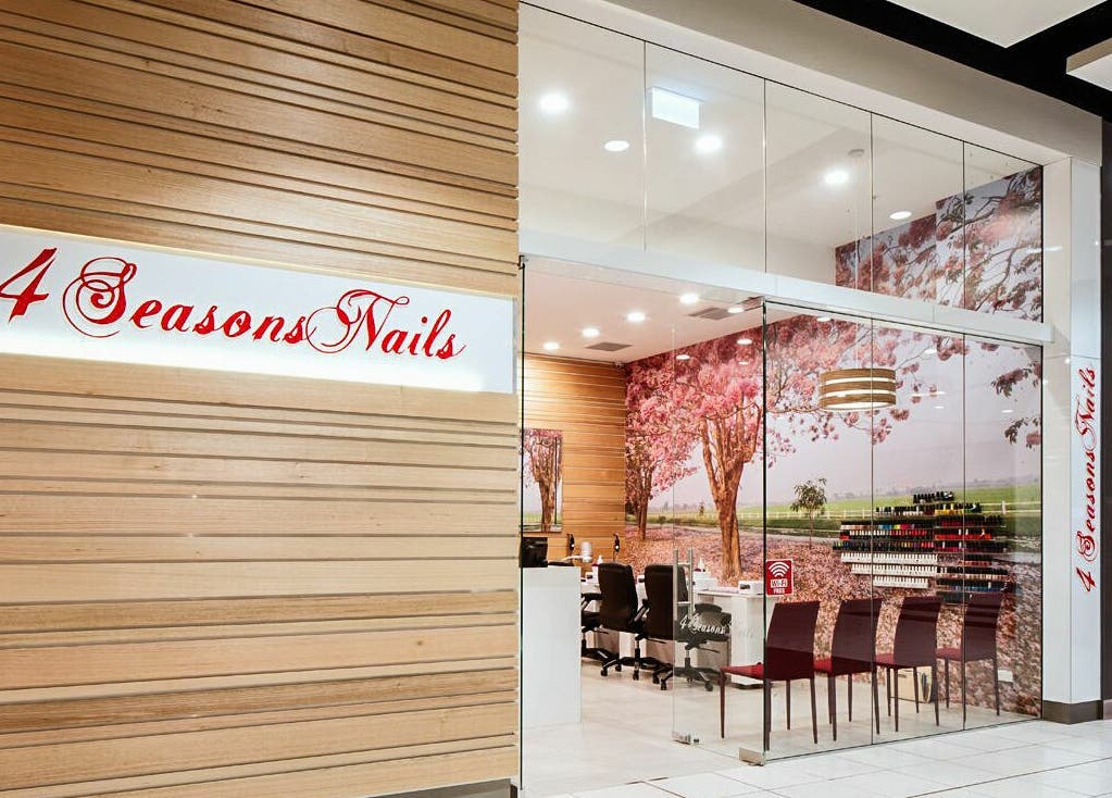 Entrance of 4 Seasons Nails Queensgate, Lower Hutt, Wellington, NZ, with cherry blossom decor and sleek design.