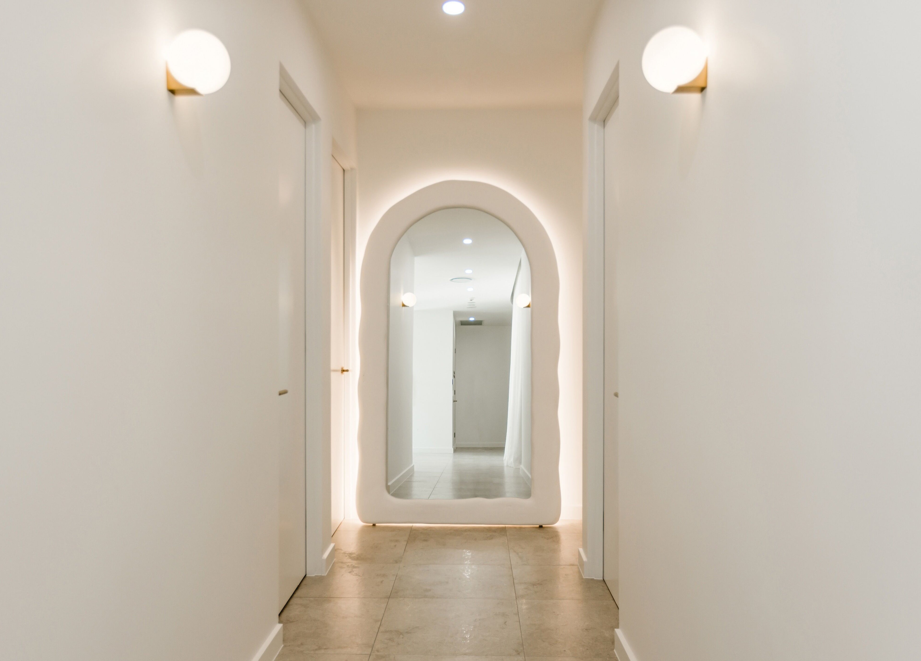 Bright hallway with arched mirror at Brow Foxx Wollongong, Corrimal, New South Wales, AU. Modern design and ambiance.