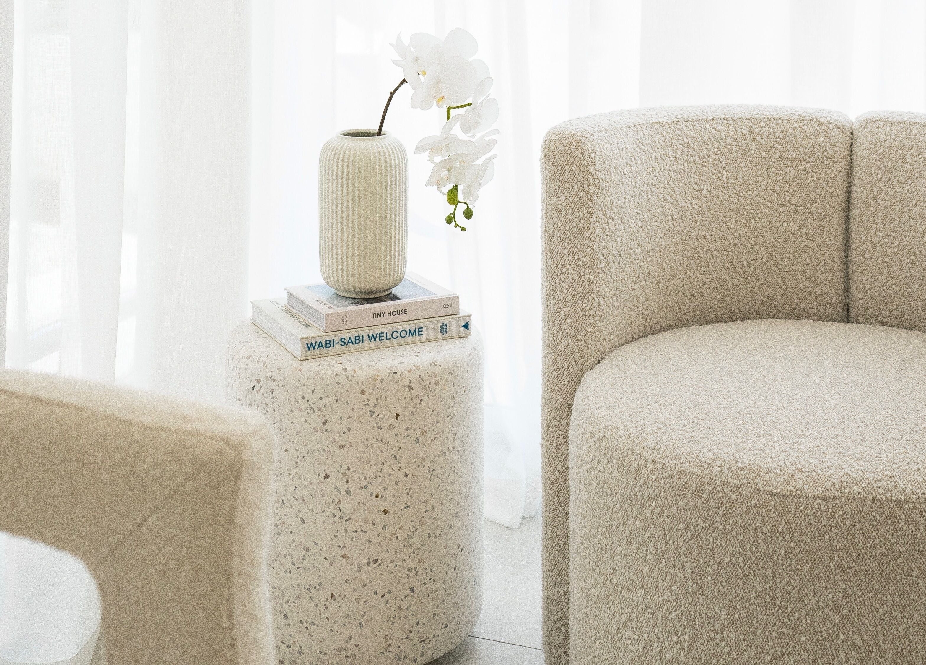 Elegant lounge seating with a vase at Brow Foxx Wollongong, Corrimal, New South Wales, AU.
