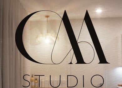 Cherie Mather Studio logo on glass door in Kardinya, Western Australia, AU with soft interior glow.