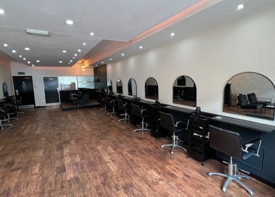 Spacious salon at SC Hairdressing in Clydebank, Scotland, GB, featuring modern styling stations and sleek decor.