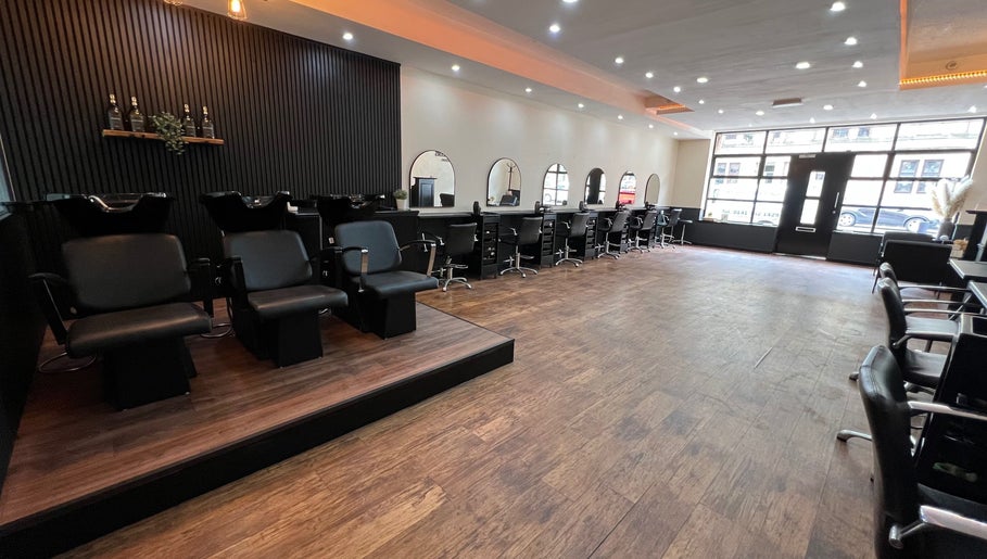 Interior of SC Hairdressing in Clydebank, Scotland, GB featuring spacious layout and modern styling chairs.