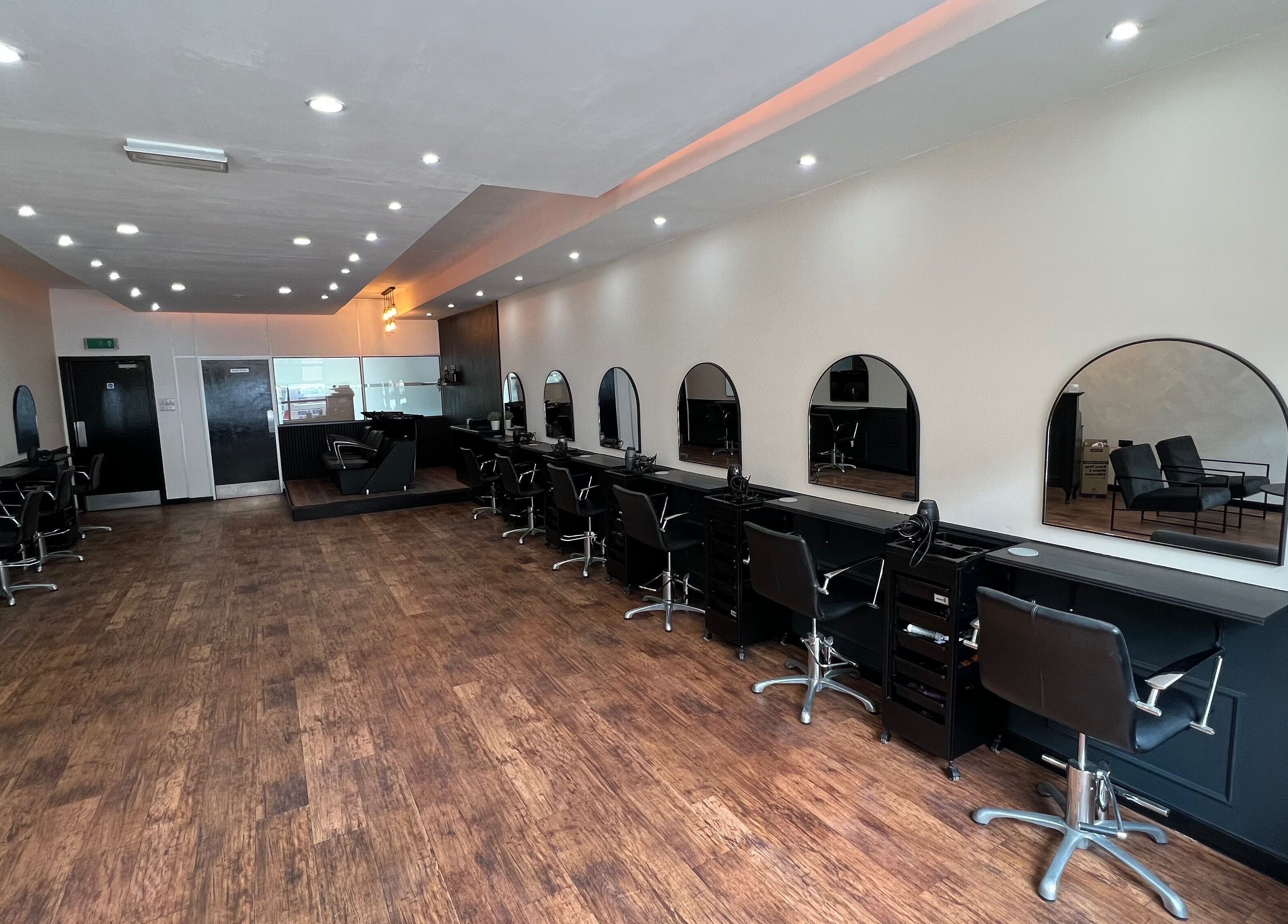 Chic interior of SC Hairdressing, Clydebank, Scotland with stylish chairs and mirrors.