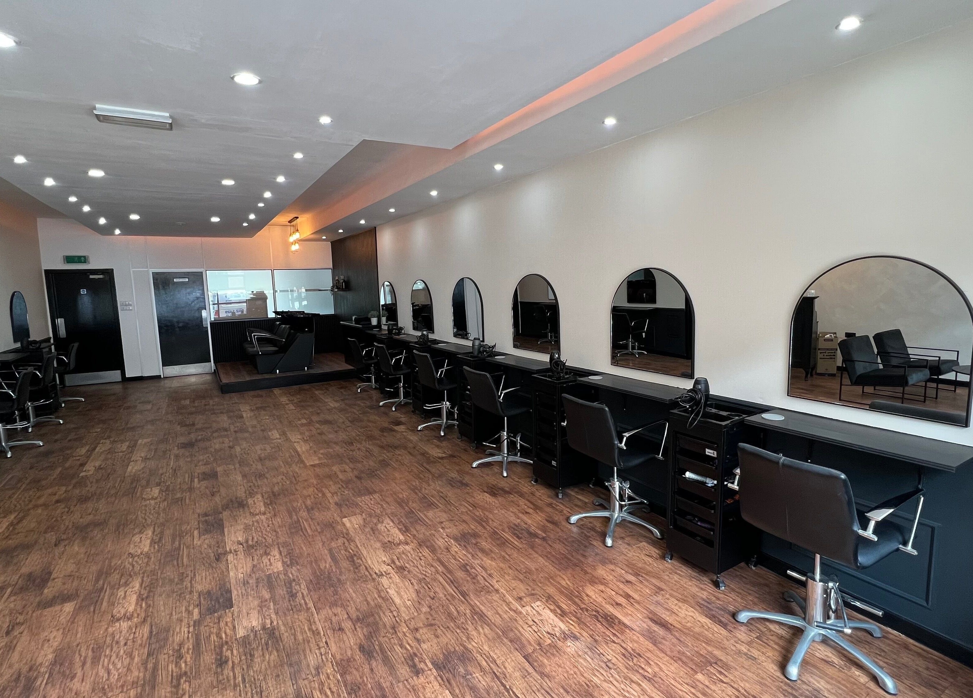 Chic interior of SC Hairdressing, Clydebank, Scotland with stylish chairs and mirrors.