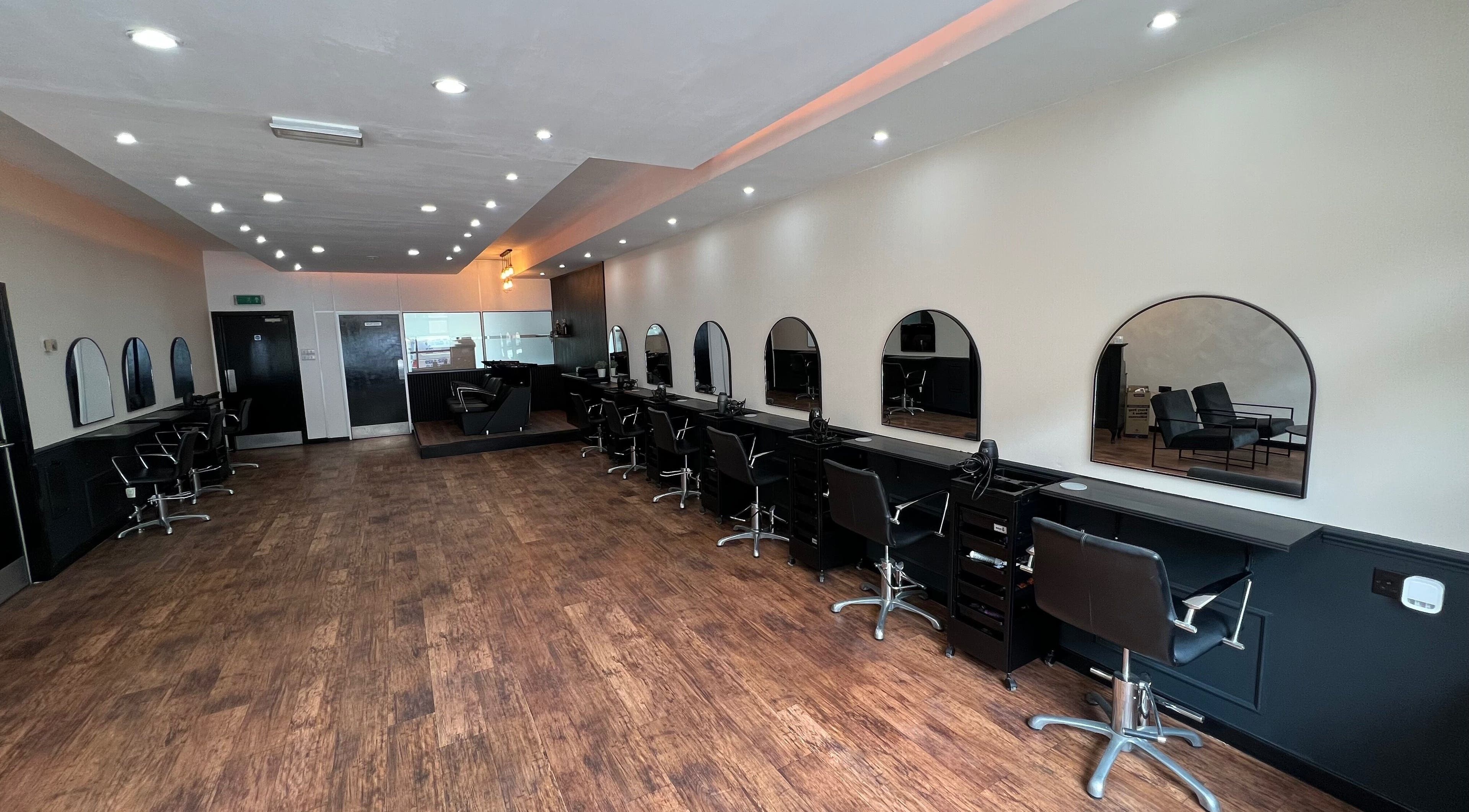 Chic interior of SC Hairdressing, Clydebank, Scotland with stylish chairs and mirrors.