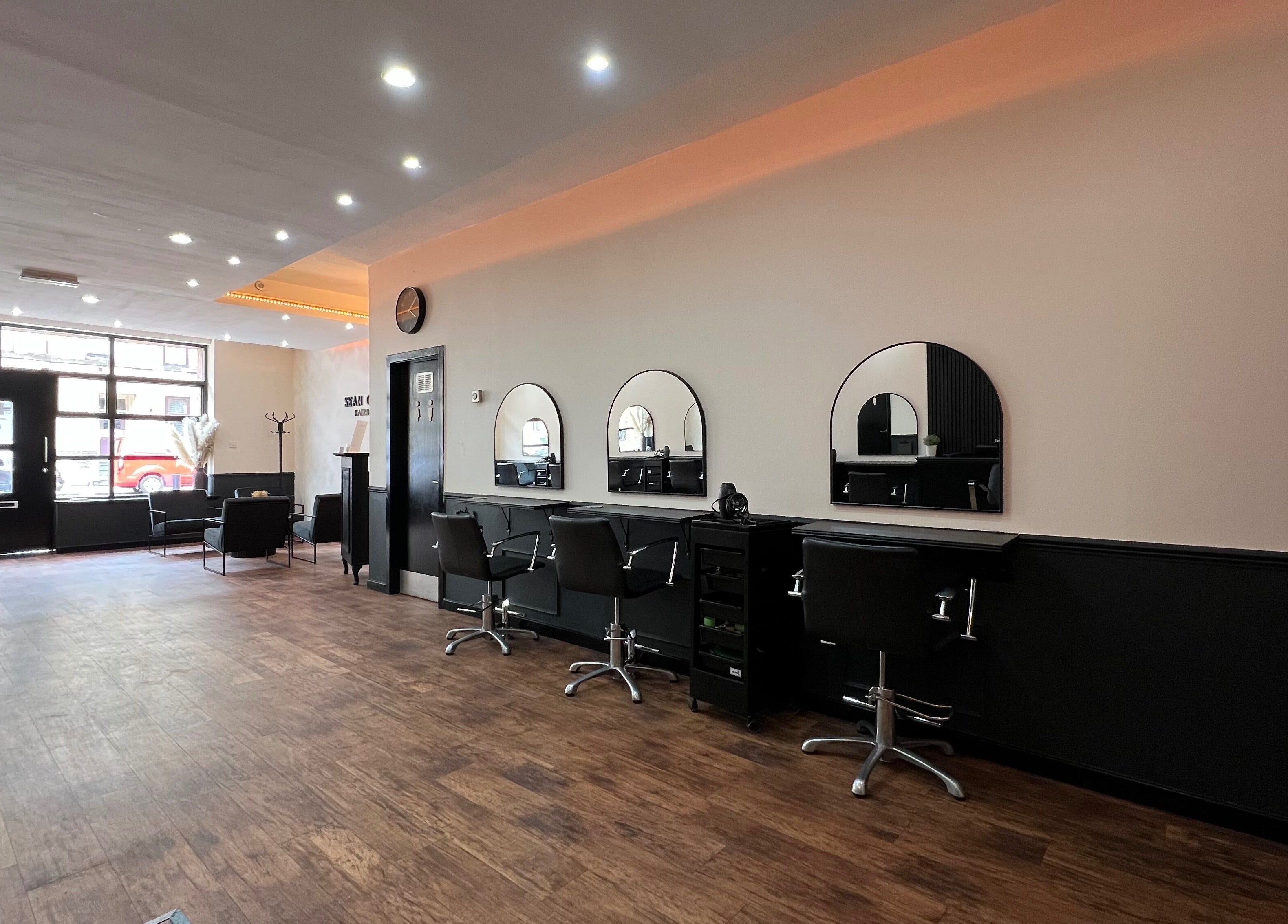 Modern, spacious interior of SC Hairdressing in Clydebank, Scotland, GB, with sleek styling stations.