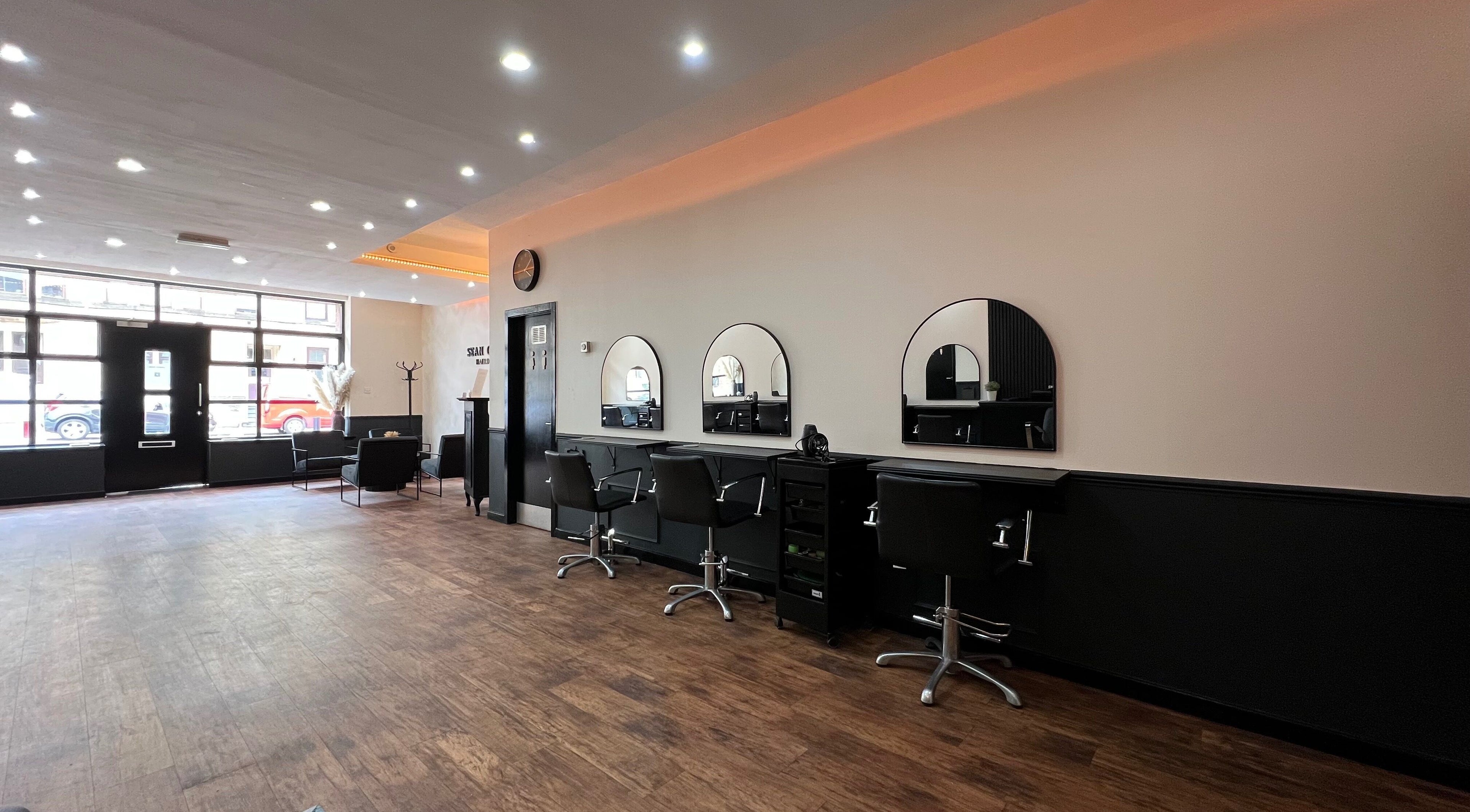 Modern, spacious interior of SC Hairdressing in Clydebank, Scotland, GB, with sleek styling stations.