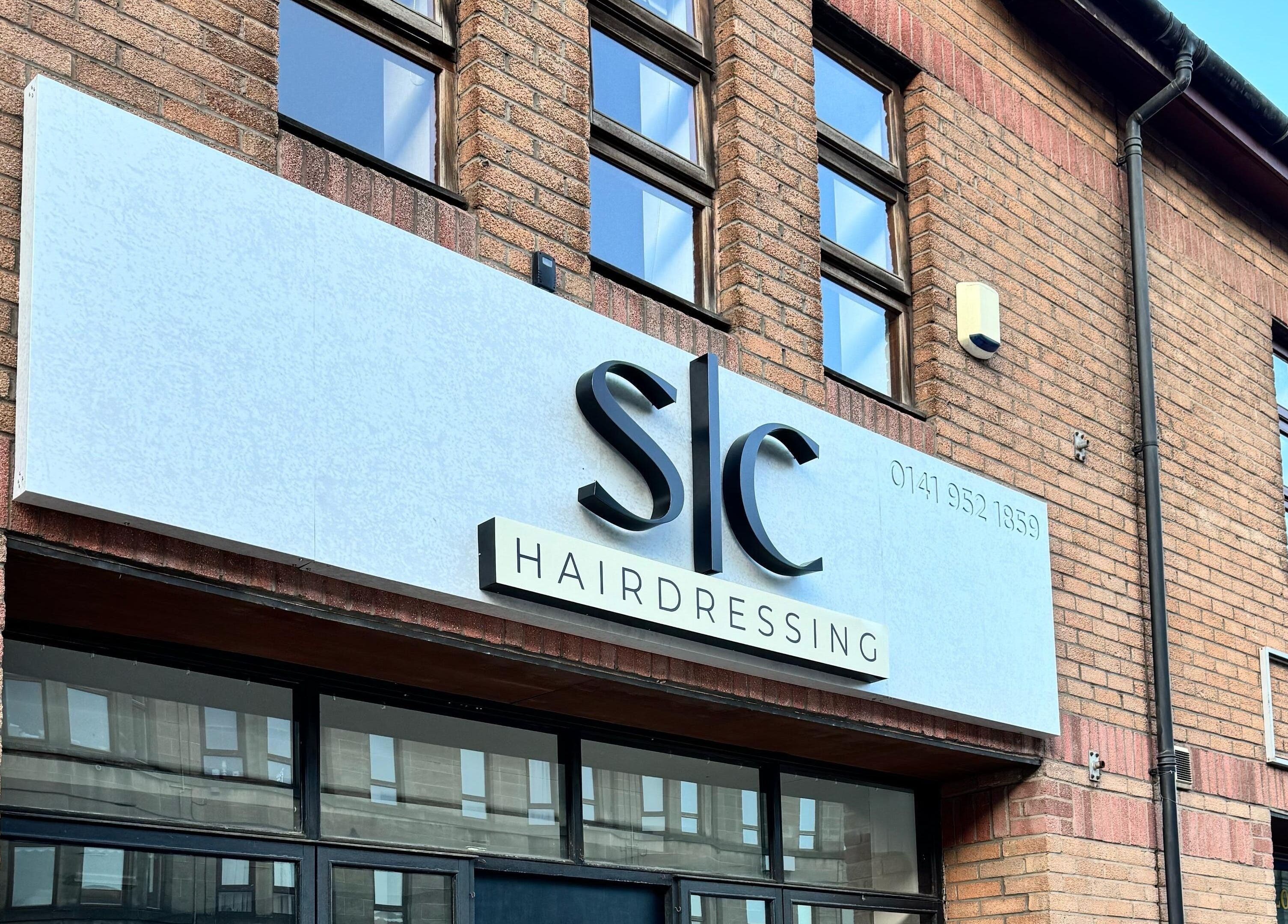 Stylish exterior of SC Hairdressing in Clydebank, Scotland, GB, showcasing its modern signage.