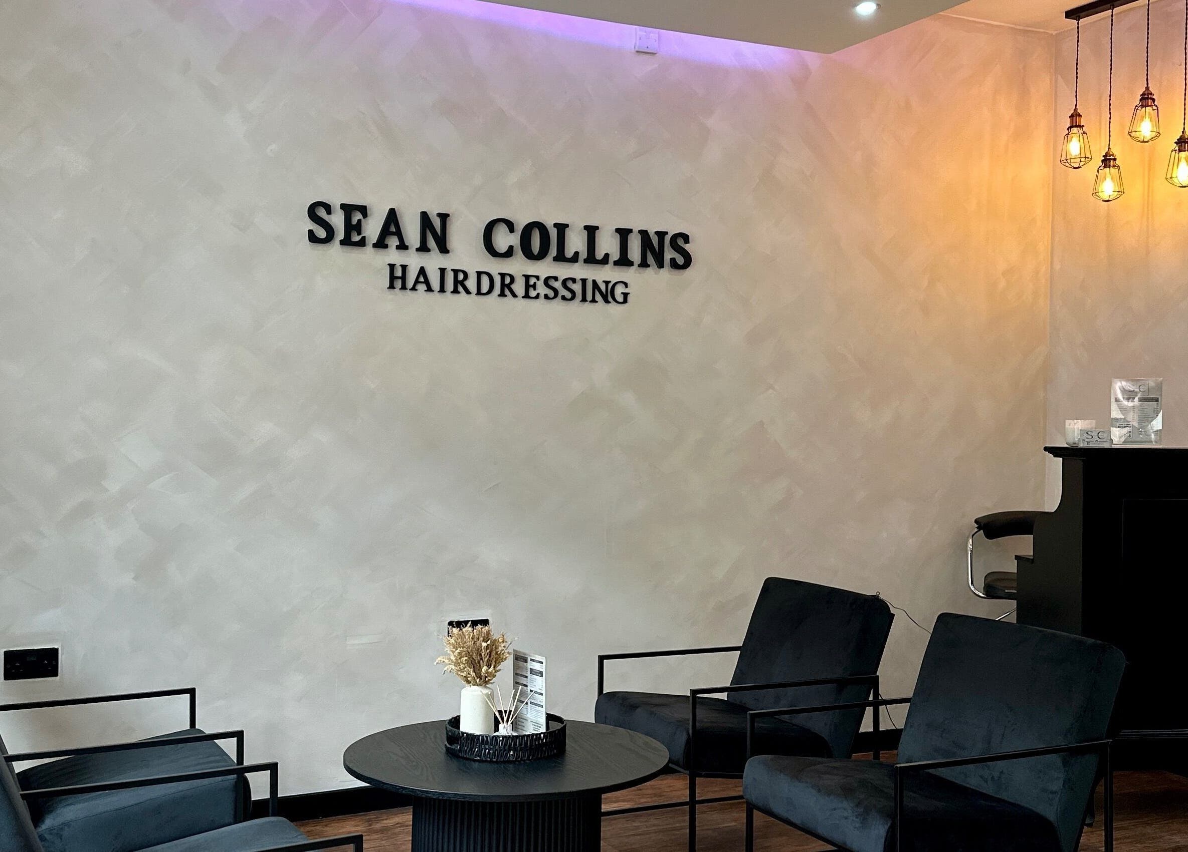 Modern waiting area at SC Hairdressing, Clydebank, Scotland, GB with stylish seating and warm lighting.