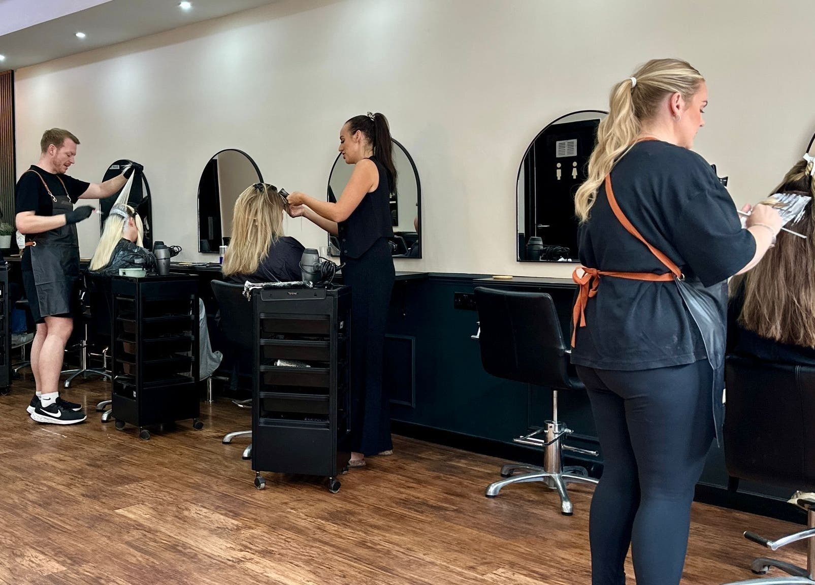 Professional hair stylists working at SC Hairdressing in Clydebank, Scotland, GB. Modern salon interior.