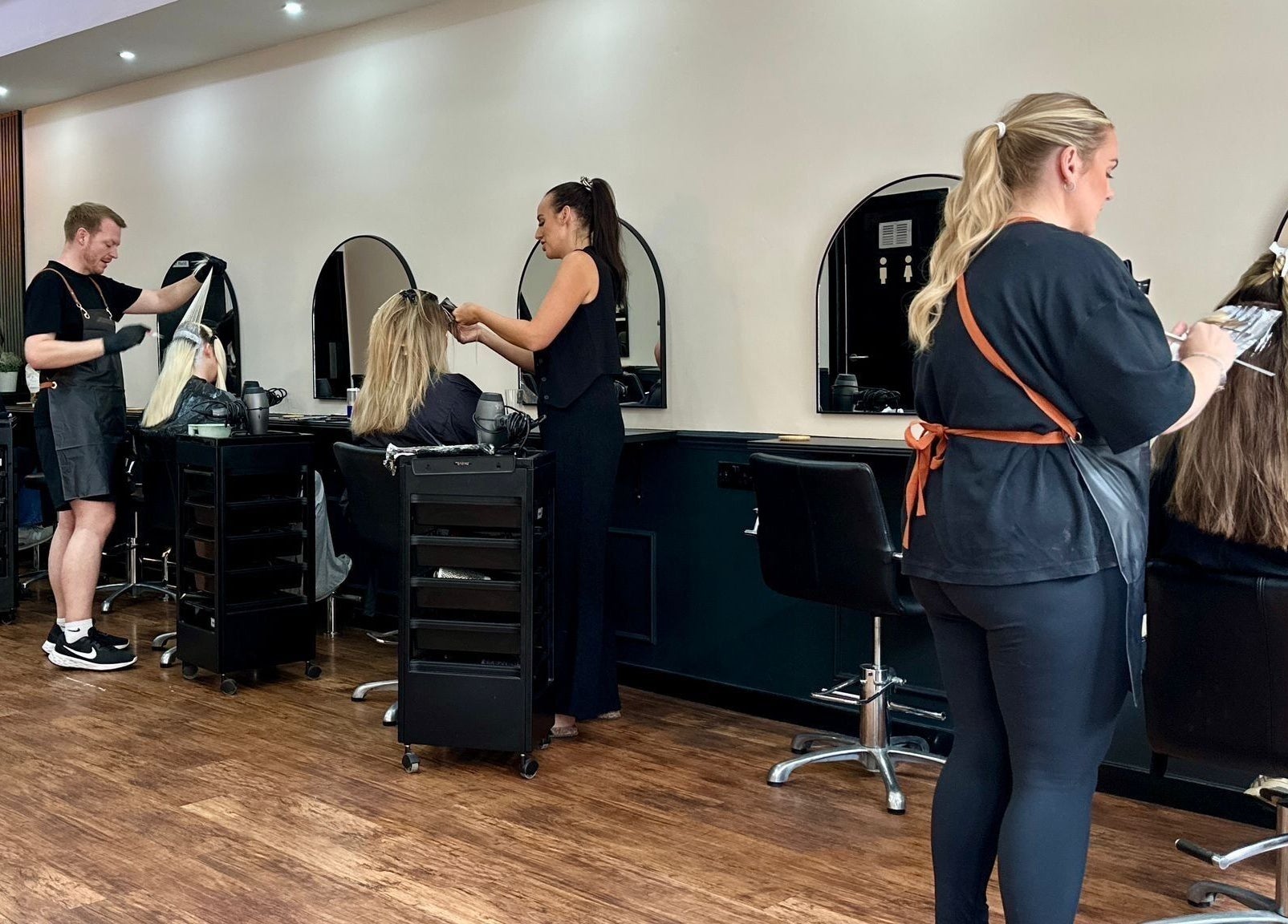 Professional hair stylists working at SC Hairdressing in Clydebank, Scotland, GB. Modern salon interior.