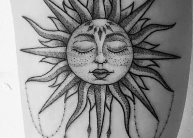 Artistic sun face tattoo at BeniSpirit.Art, Stockton-on-Tees, England, GB.