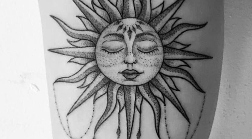Artistic sun face tattoo at BeniSpirit.Art, Stockton-on-Tees, England, GB.