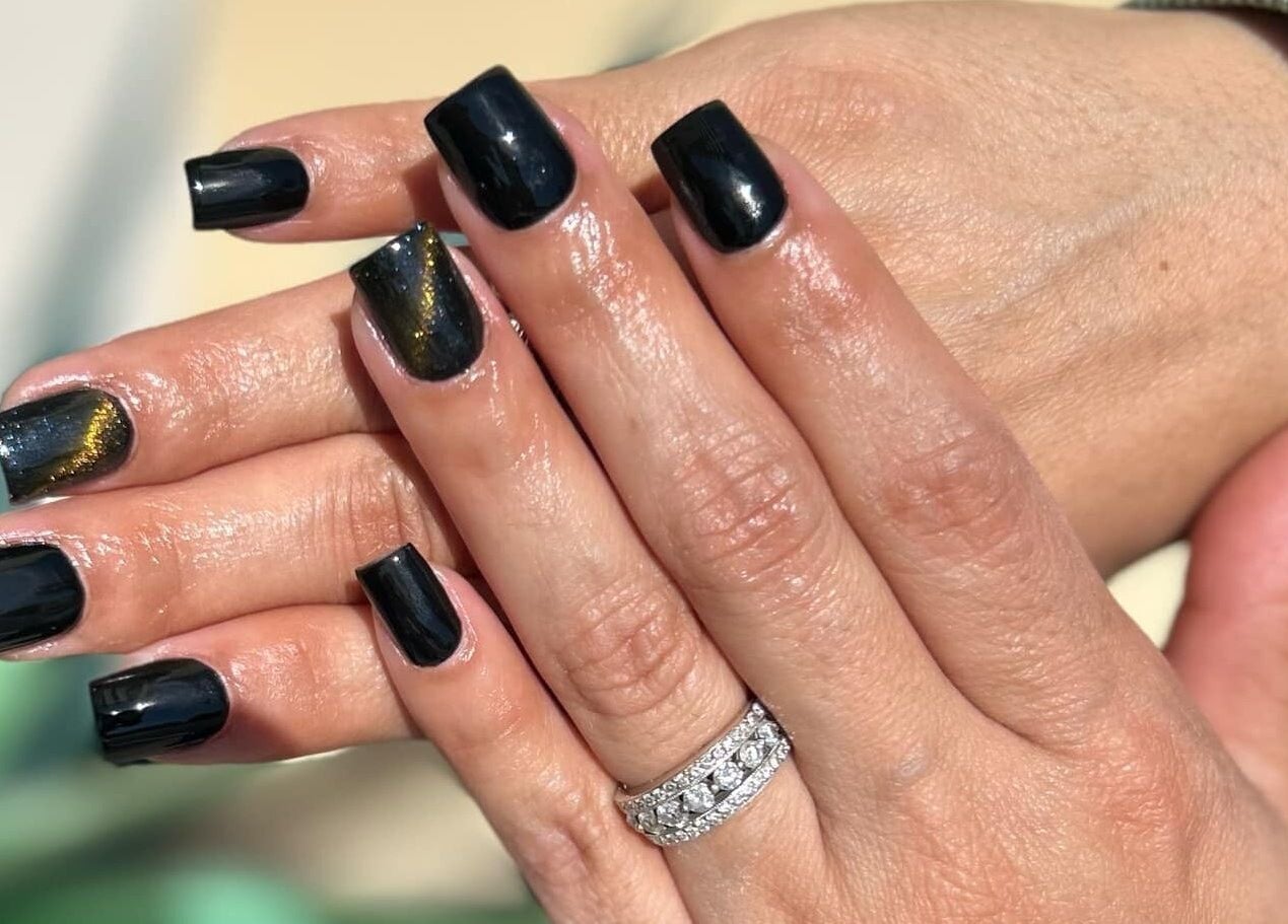 Elegant black manicured nails at Lovely Me Nail Studio, Laredo, Texas, US, featuring a shiny finish.